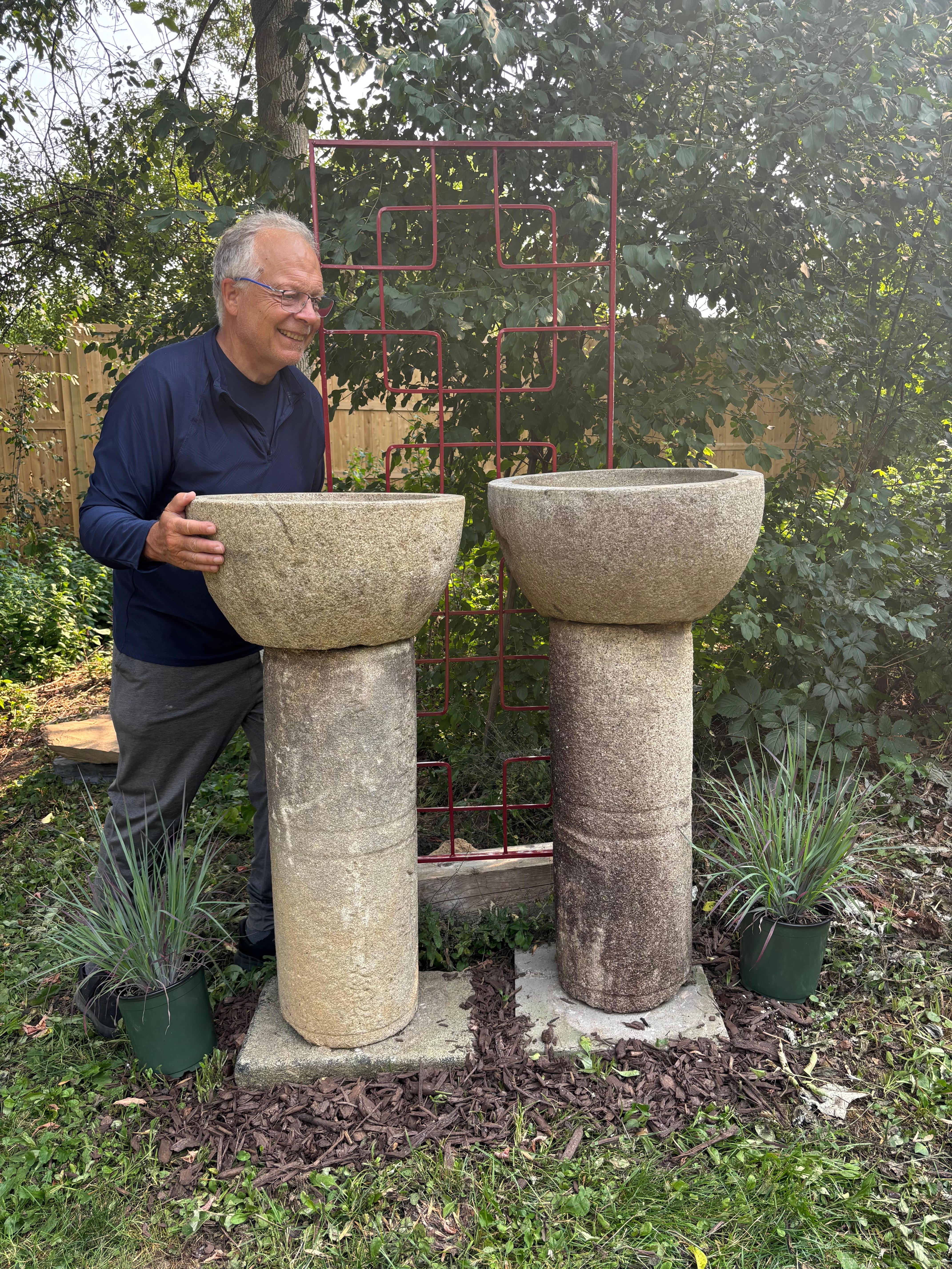 Unique Pair (2) Tall Large Round Stone Bowls Planters On Stone Pedestals

From our recent Japanese Acquisition Travels- comes this unusual pair of tall large round garden stone vessels on pedestals  with inset carved handles - perfect as elegant