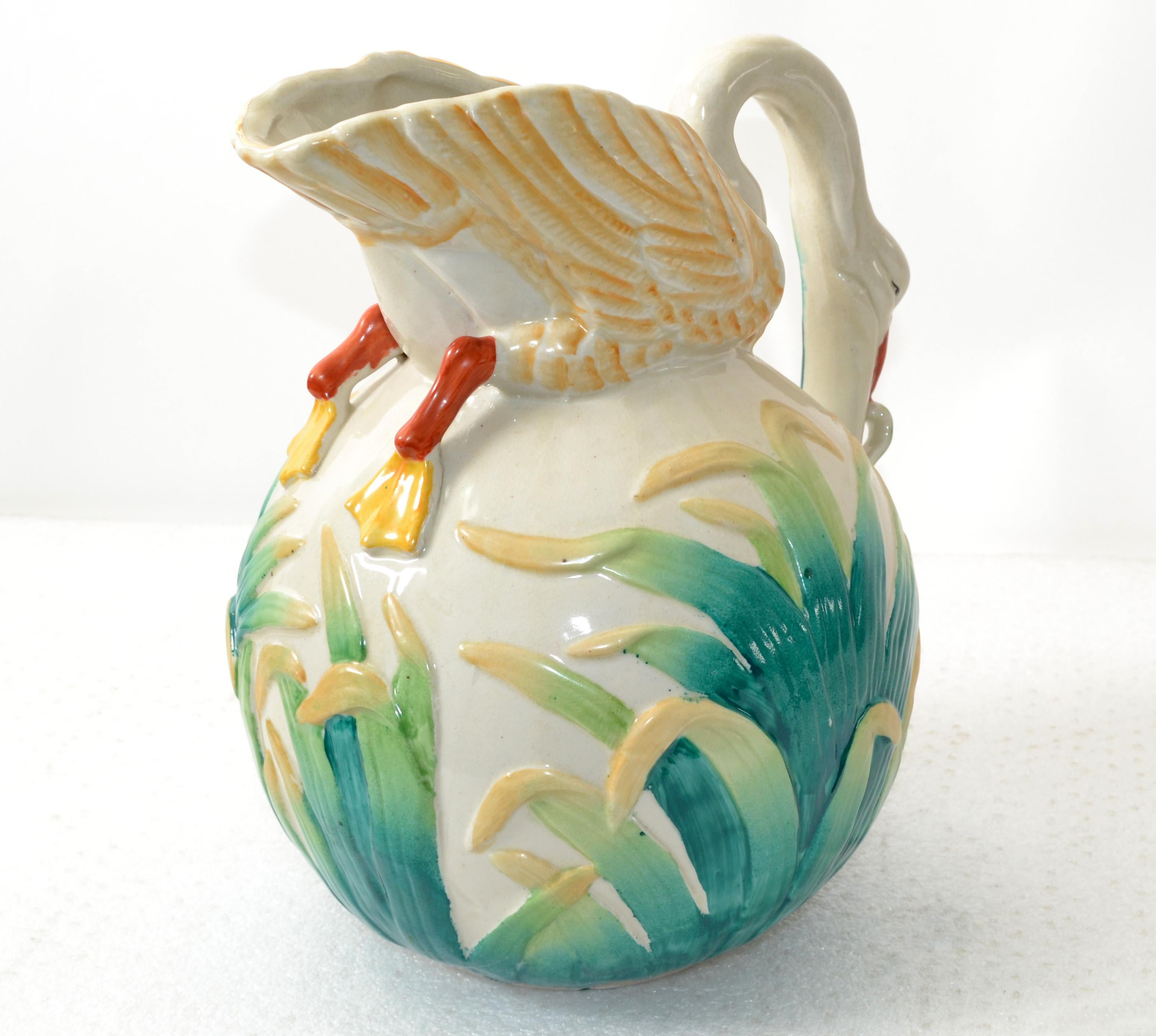 This Victorian water pitcher antique glazed and hand painted ceramic jar, decanter was made in Japan, circa 1890.
The Pitcher themed a Swan grassing in a rice field. The opening has a Gold Leaf Border.
This colorful Pitcher is in very good