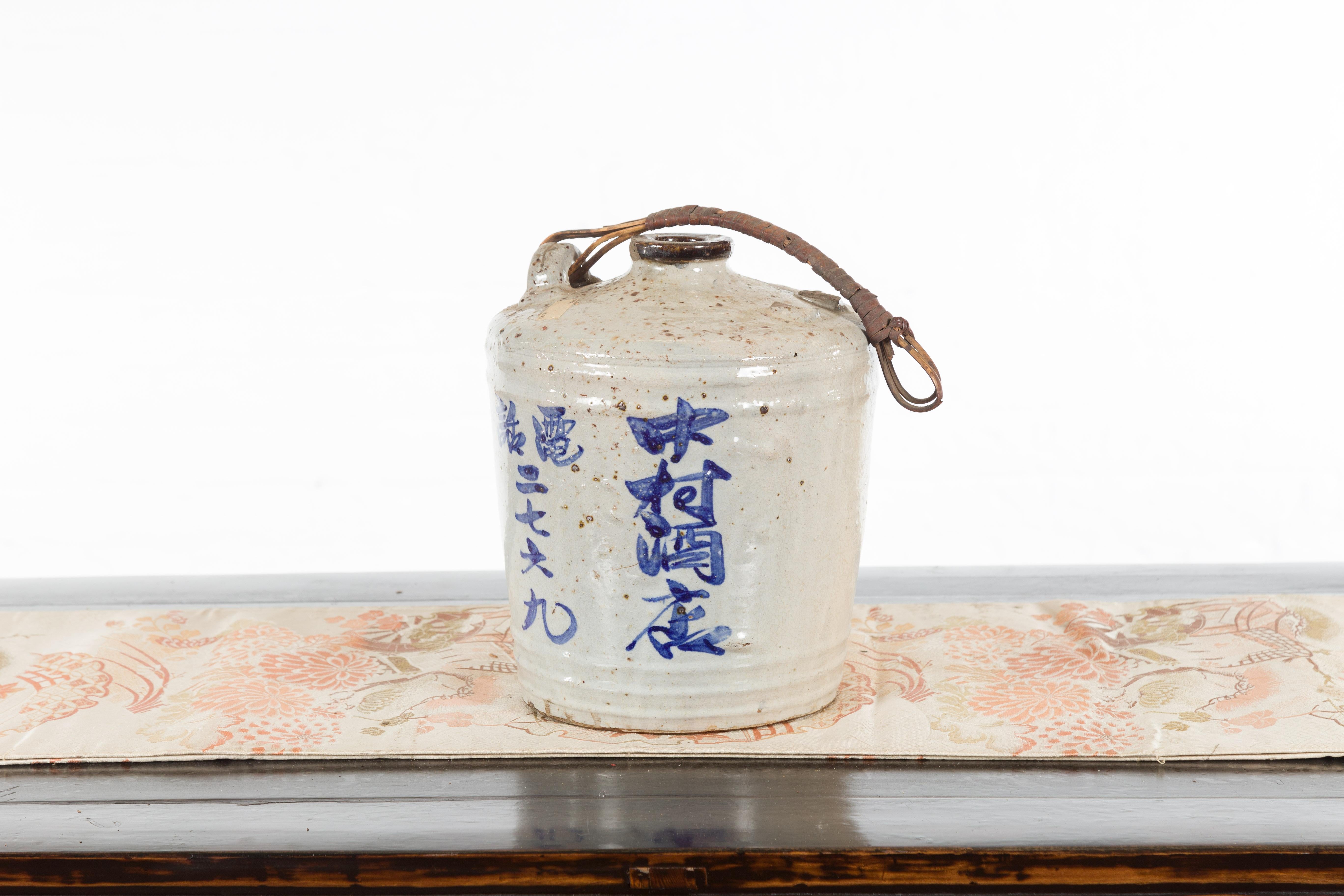 Japanese 19th Century Ceramic Jug with Blue Calligraphy and Rattan Handle 7