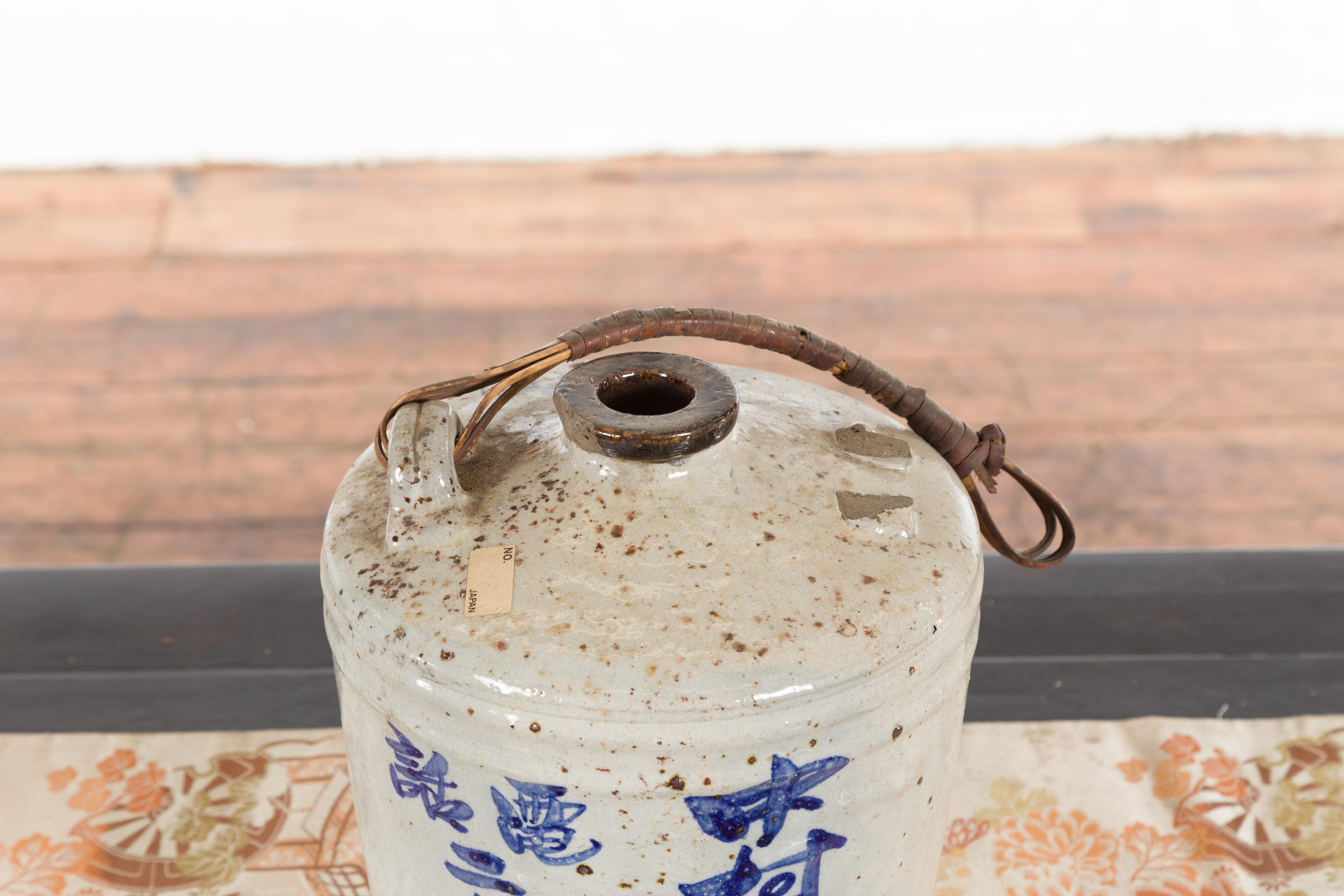 Japanese 19th Century Ceramic Jug with Blue Calligraphy and Rattan Handle 2