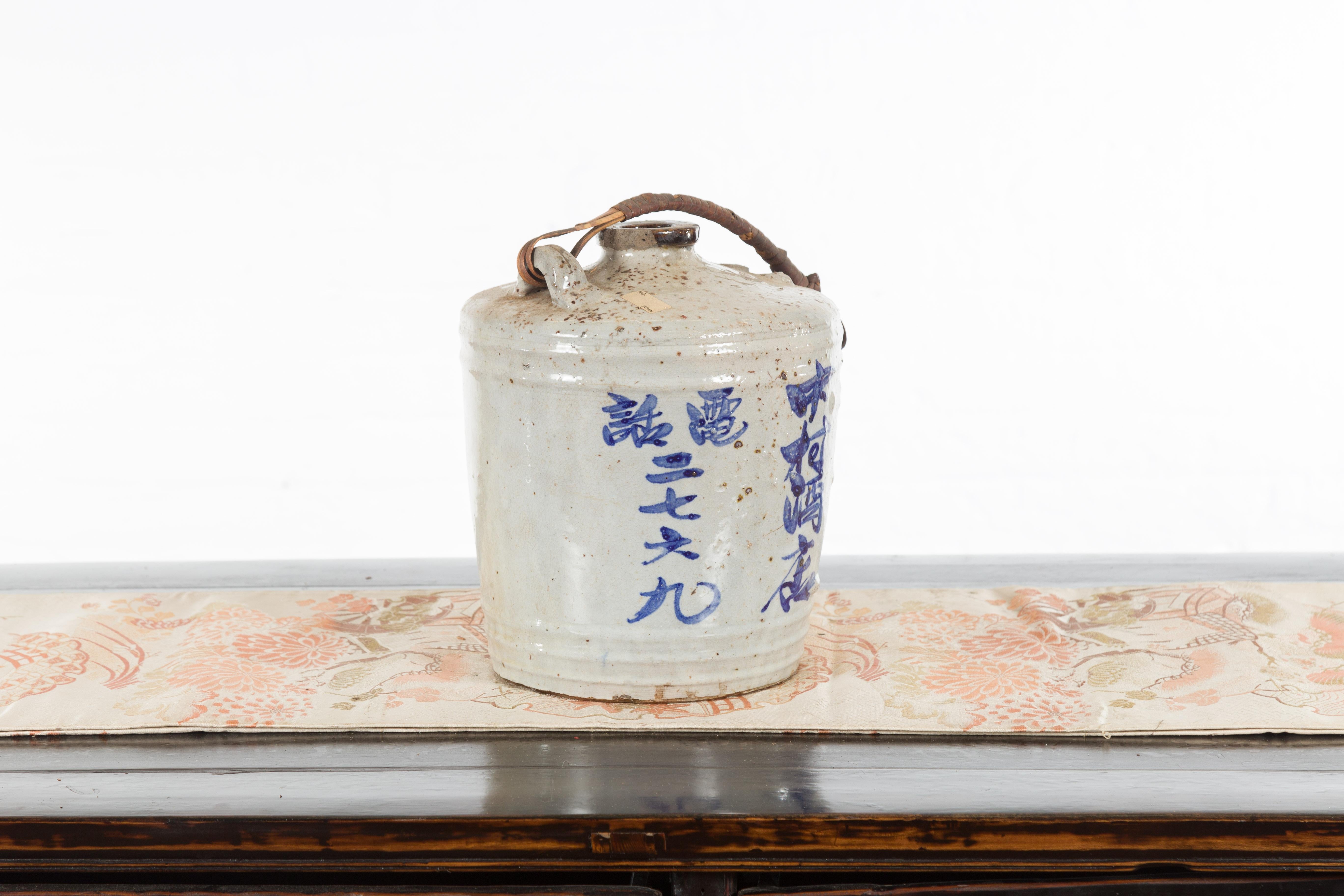 Japanese 19th Century Ceramic Jug with Blue Calligraphy and Rattan Handle 3