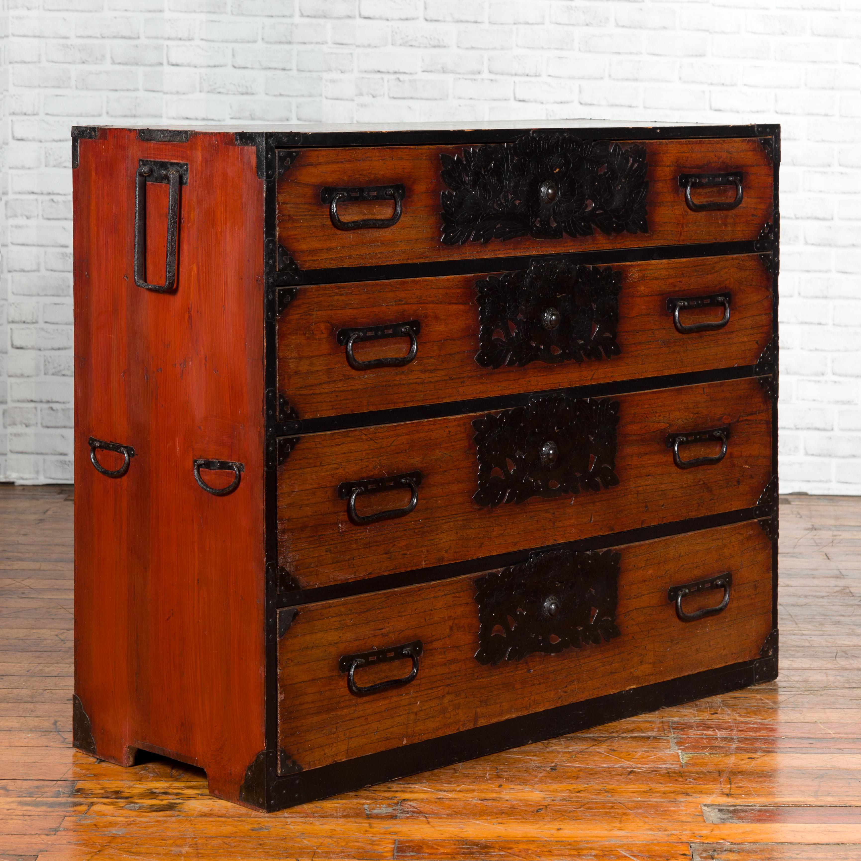 A Japanese 19th century keyaki wood Sendai clothing tansu (Isho-dansu) with four drawers and elaborate handcut iron hardware. Born during the 19th century in the Sendai prefecture, this wooden Tansu chest is a Fine example of Japan's traditional