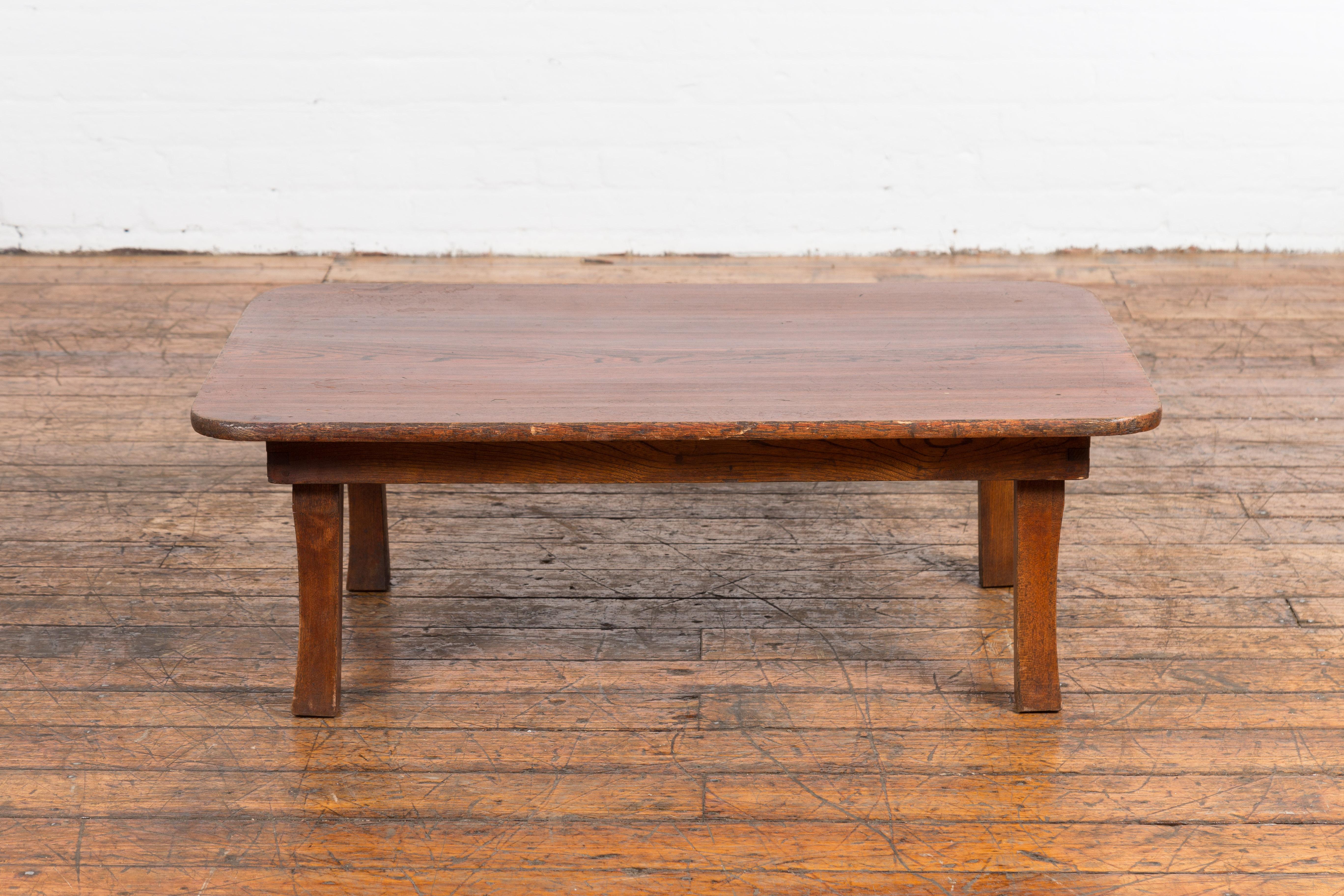 An antique Japanese low table from the 19th century with folding legs. Introduce a touch of elegance to your living space with this exquisite antique Japanese low table from the 19th century. Designed to serve as a drinks or coffee table, this piece