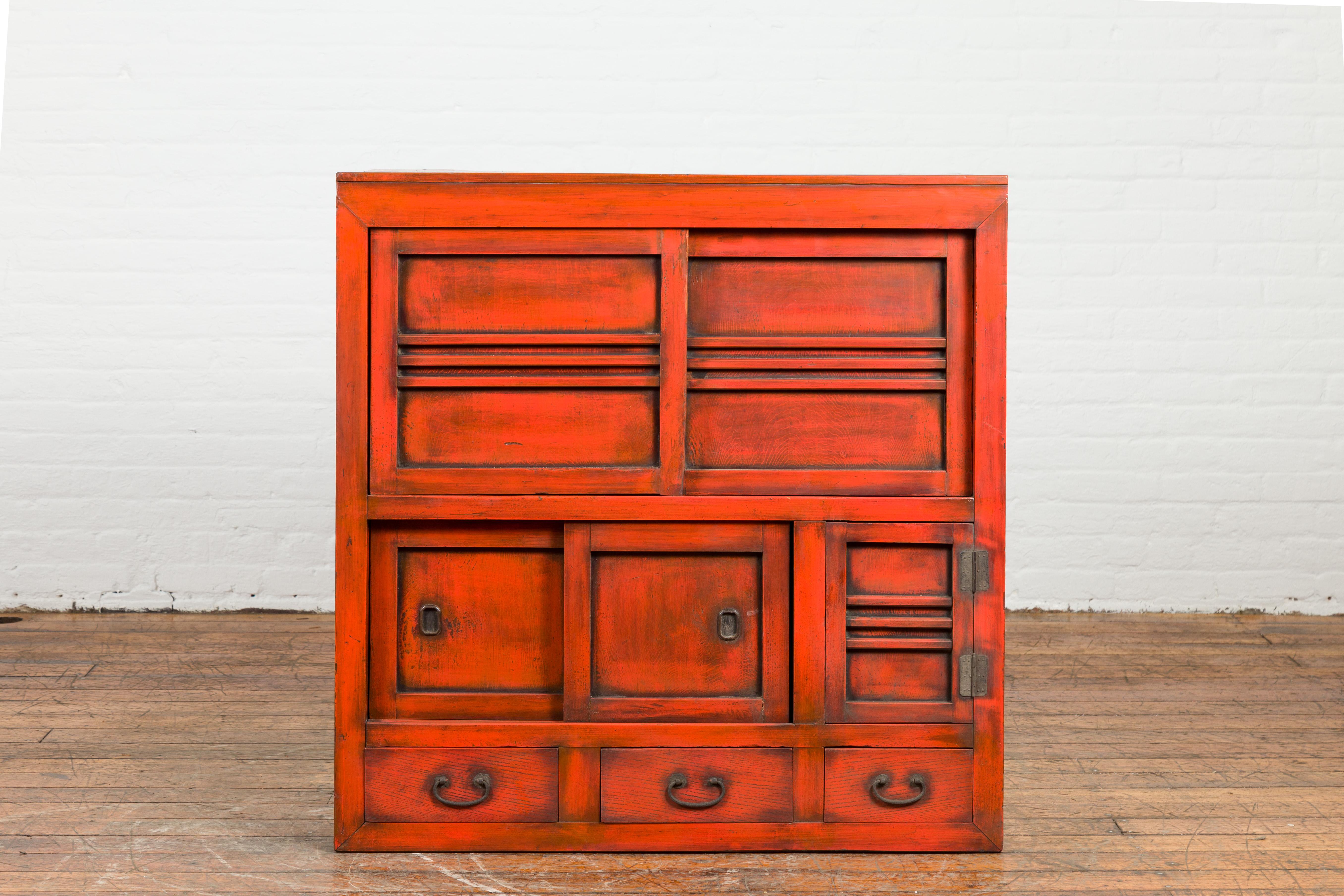 A Japanese Meiji period red cabinet from the late 19th century, with sliding doors and drawers. Created in Japan during the Meiji period, this cabinet attracts our attention with its red structure and convenient design. Sliding doors open to reveal