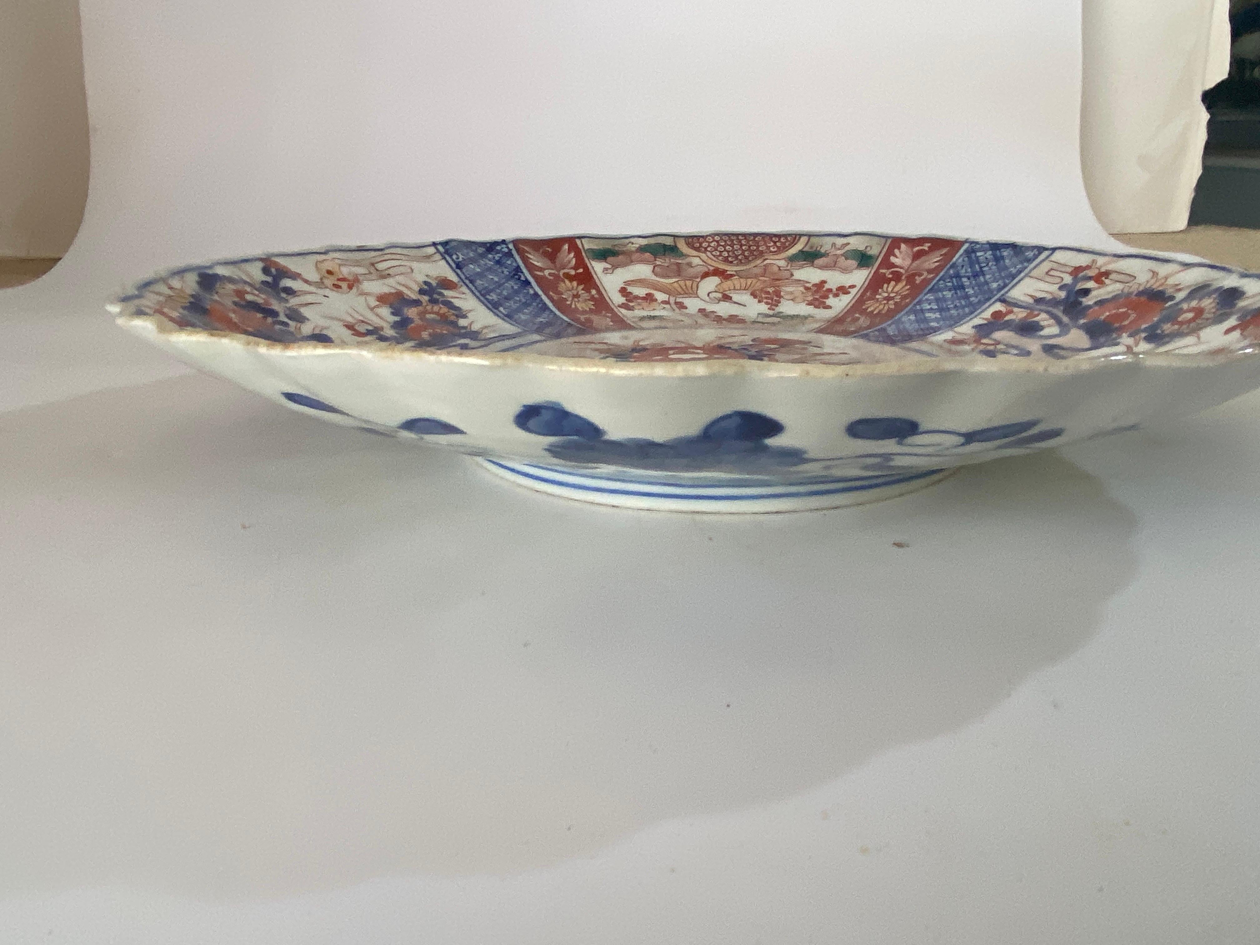 Japanese Dish or Charger, made in Japan at the beginning of the 19th century. With beautiful colors in red blue and white. The Item is in good condition.