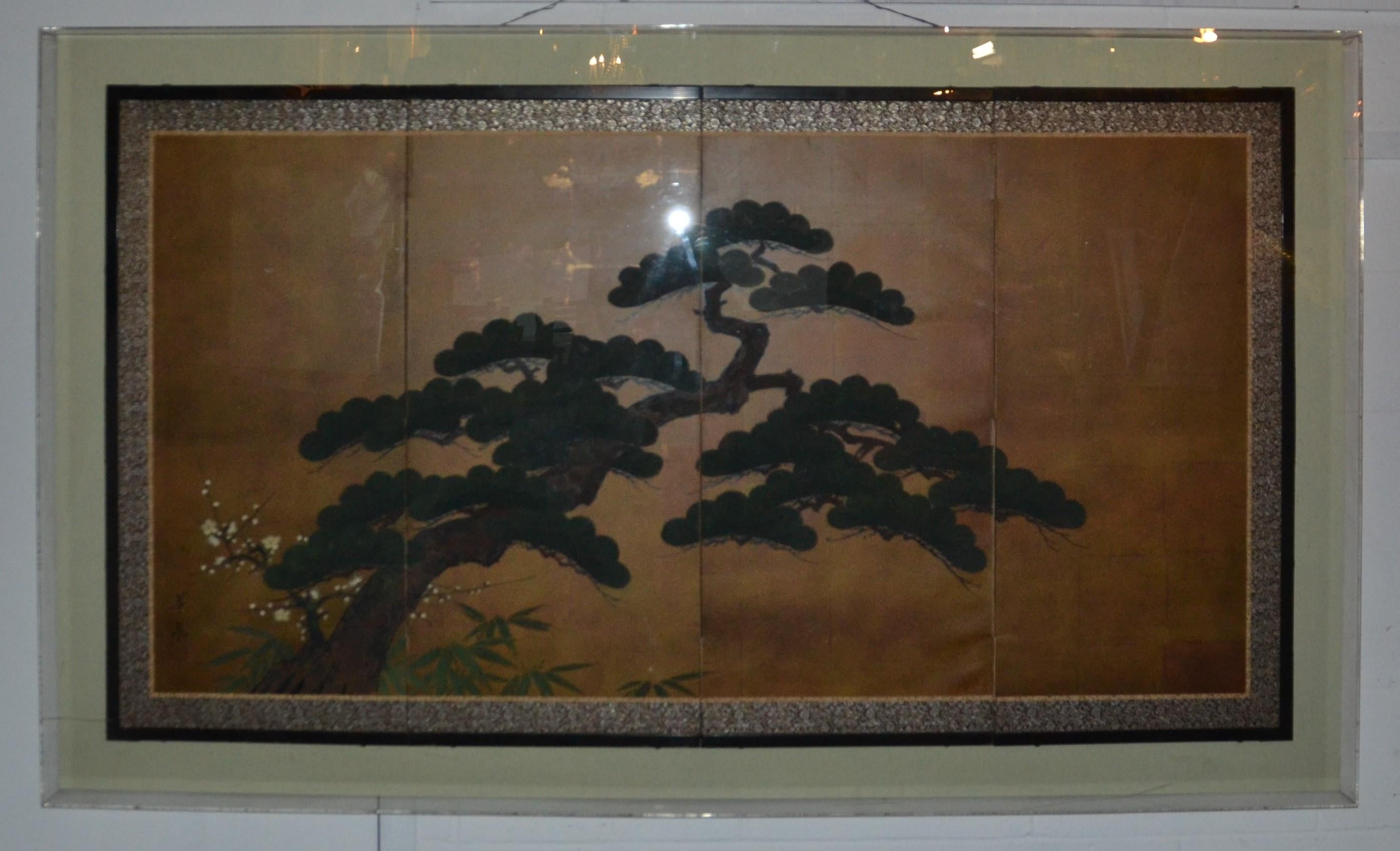 A Japanese 4 panel screen with a gilt background and a painted bonsai tree. The screen is framed in a Lucite 