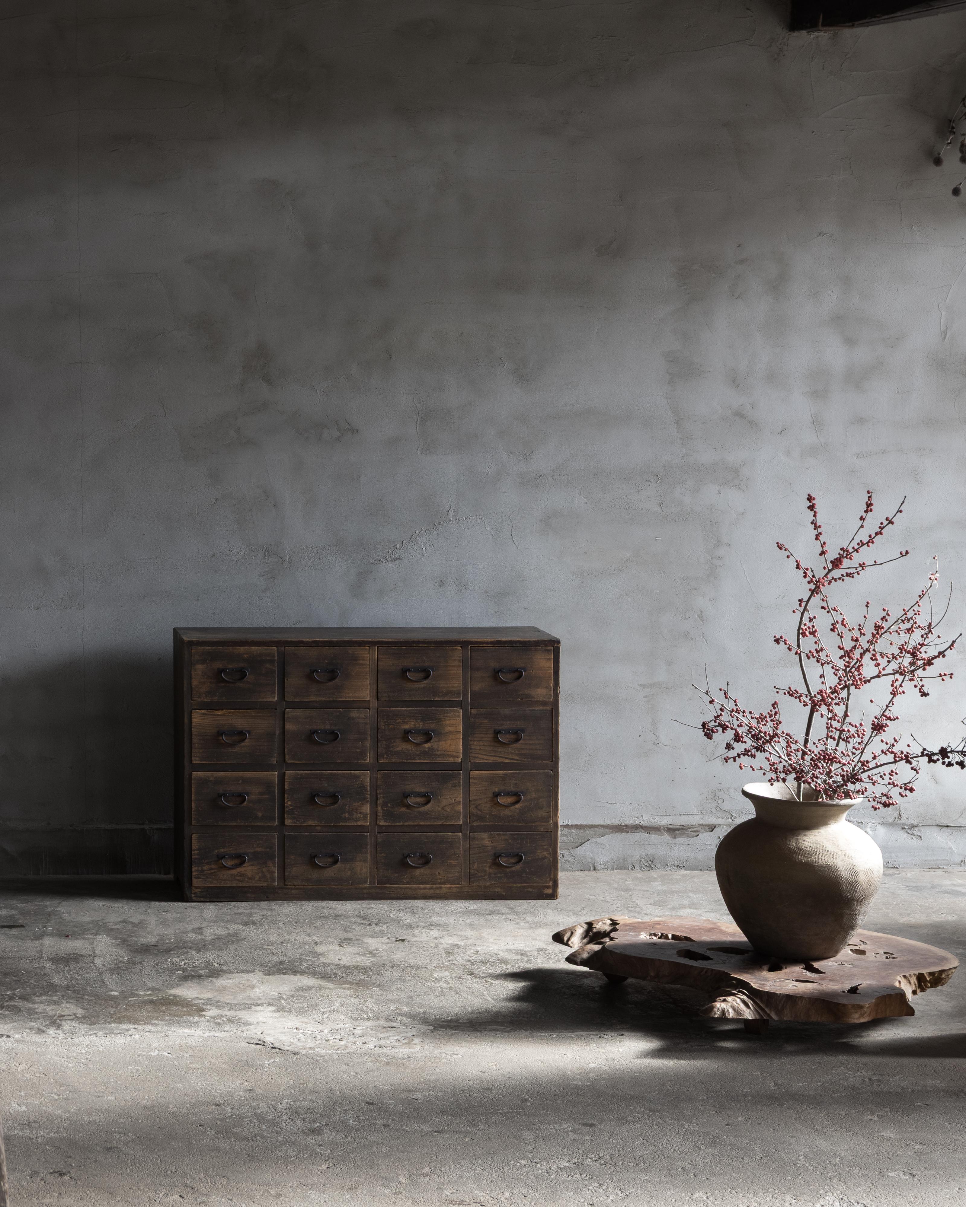 This Japanese apothecary chest (kusuri tansu) was crafted during the Taisho Period (1912–1926) in hinoki cypress, a wood prized for its fine grain, natural resistance to moisture, and subtle, calming fragrance.

The design is rooted in practicality:
