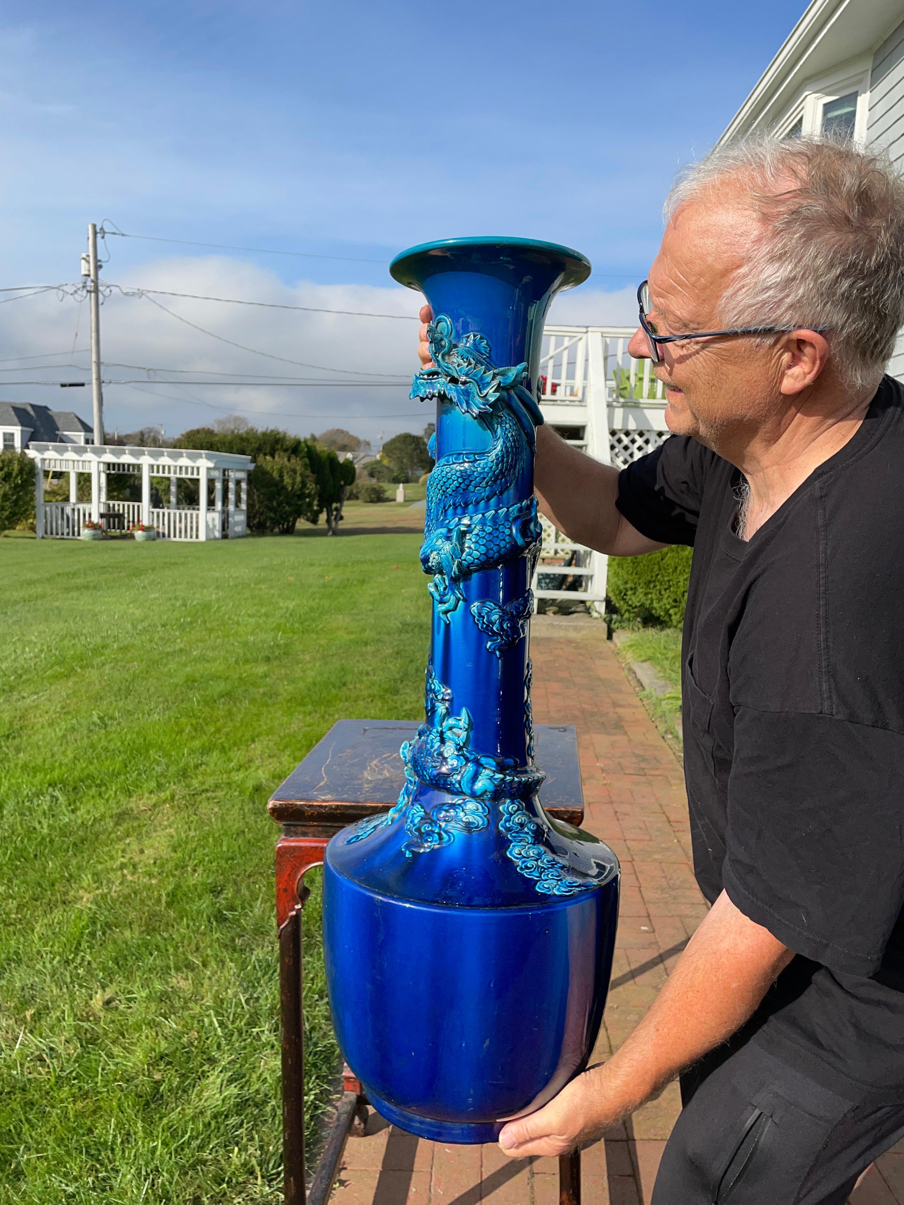 Japon, un vase dragon monumental antique de 37 pouces à glaçure craquelée bleu cobalt, avec un impressionnant dragon enroulé autour de sa tige.

Il a été fabriqué par les maîtres artisans du four japonais d'Awaji, dans le sud du pays, entre la fin