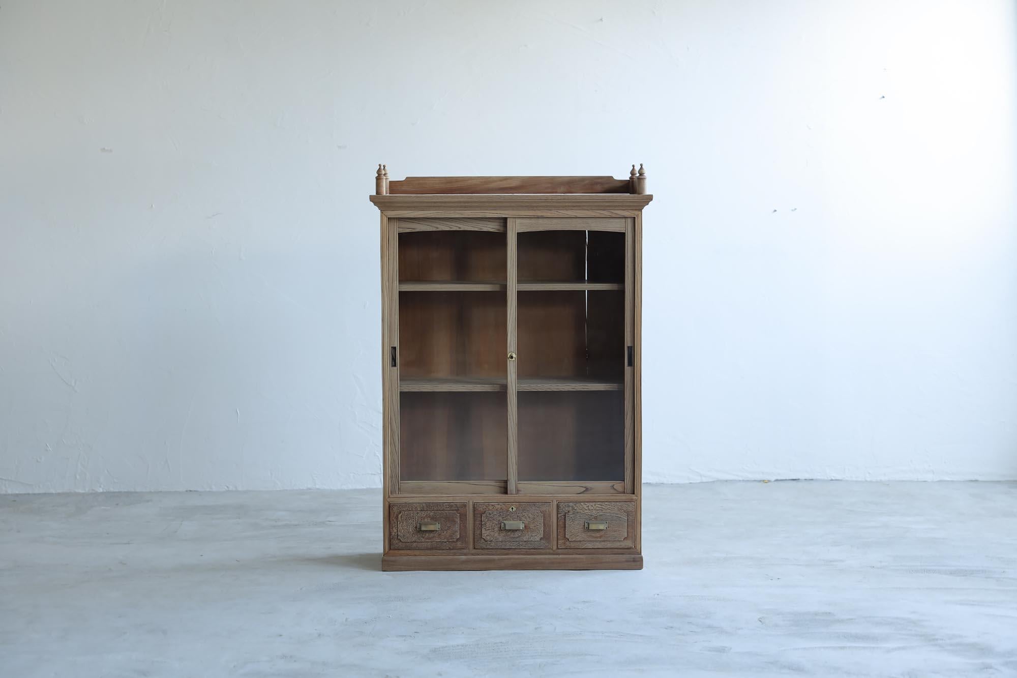 This is an antique Japanese cabinet made during the Taisho period.

This furniture was made with the same tradition and advanced techniques as Japanese shrines. An advanced joining technique called ken-dome (sword clasp) is used to beautifully