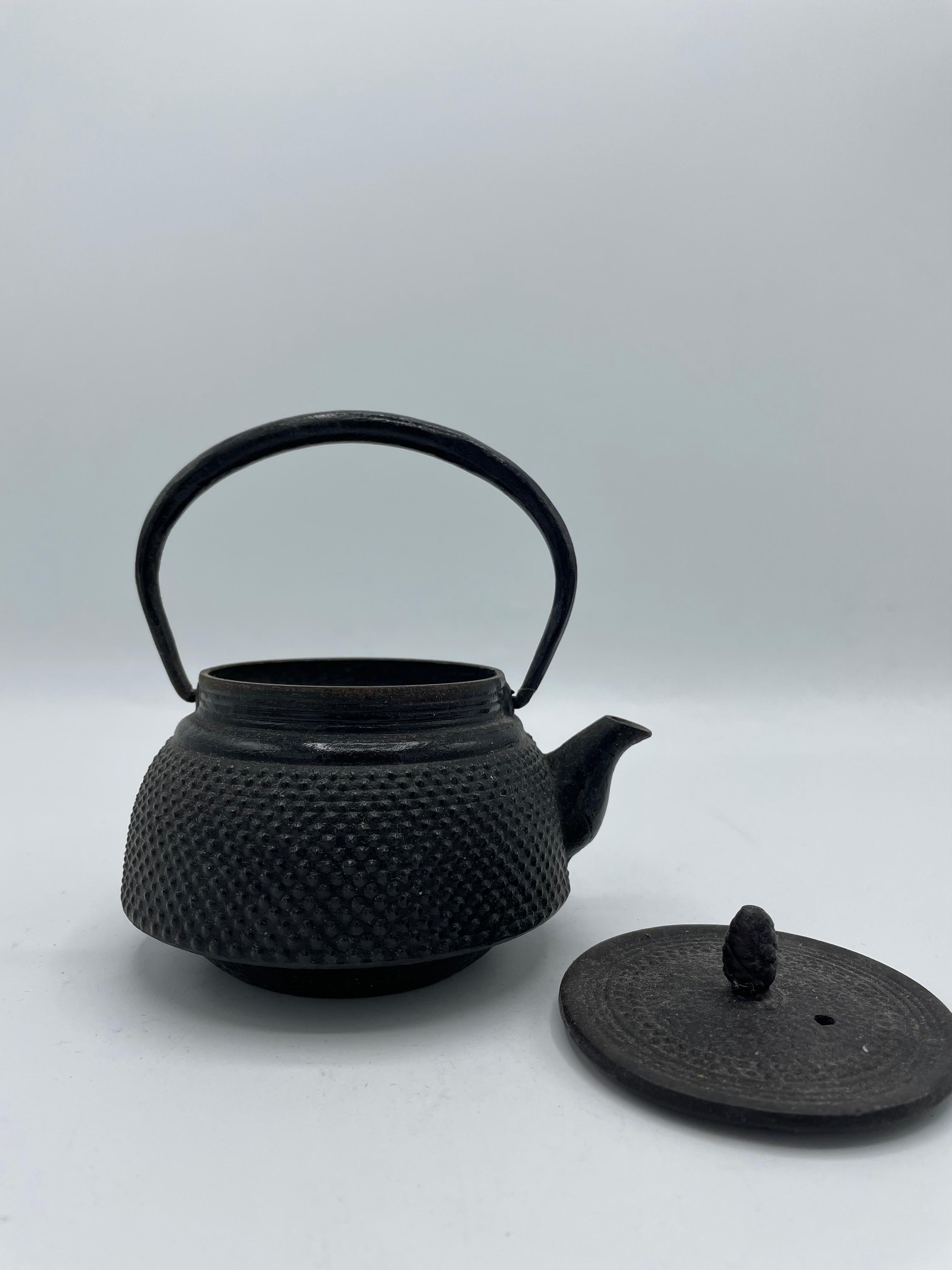 This kettle was made in 1980s, in Showa era. 
The cast iron kettles like this item are called 'Tetsubin' in Japan.
It can be put on the fire or an induction plate. Also we can use it as decoration.
Do not scratch the bottom of the kettle to leave