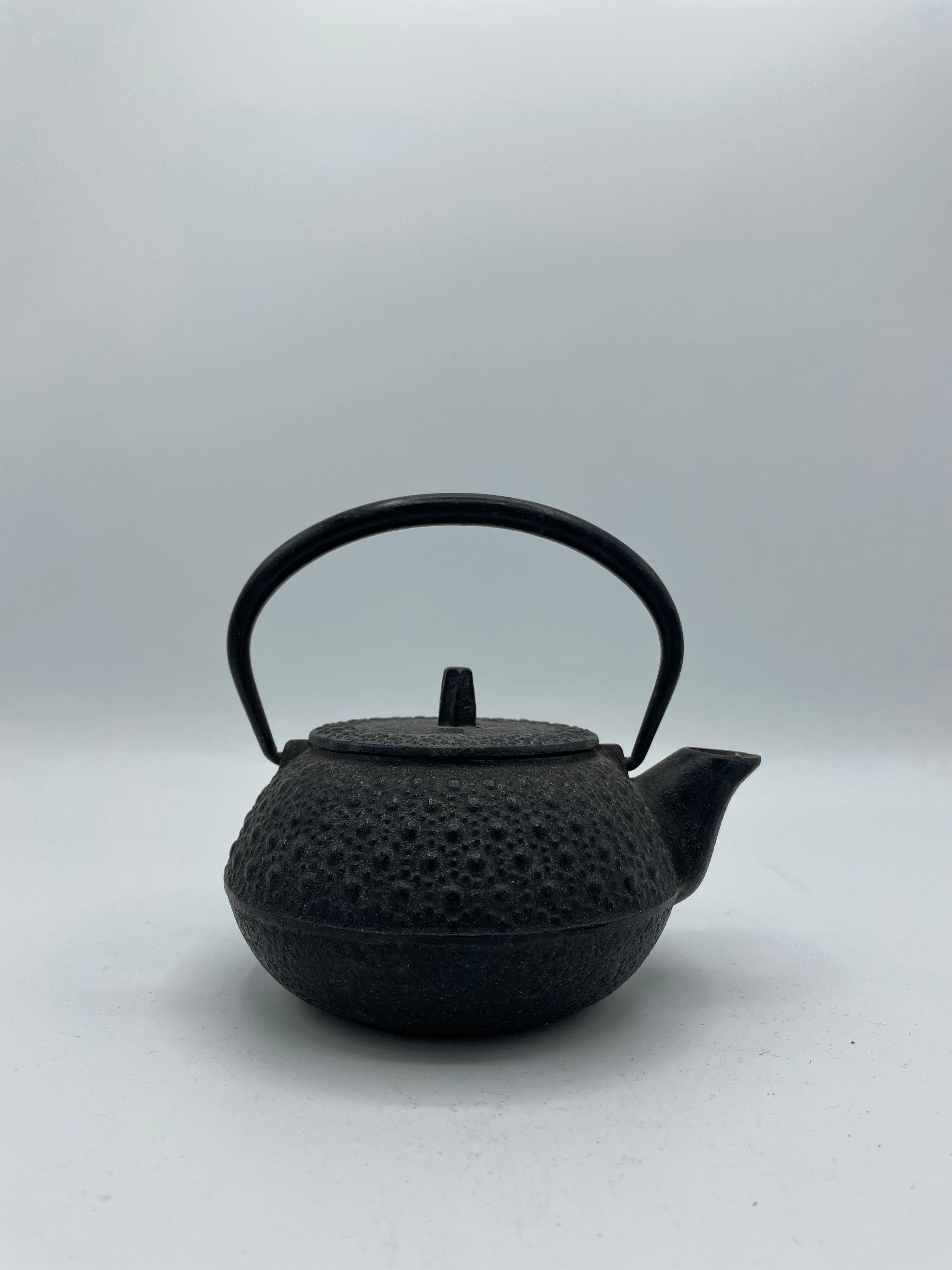 This kettle was made in 1980s, in Showa era. 
The cast iron kettles like this item are called 'Tetsubin' in Japan.
It can be put on the fire or an induction plate. Also we can use it as decoration.
Do not scratch the bottom of the kettle to leave