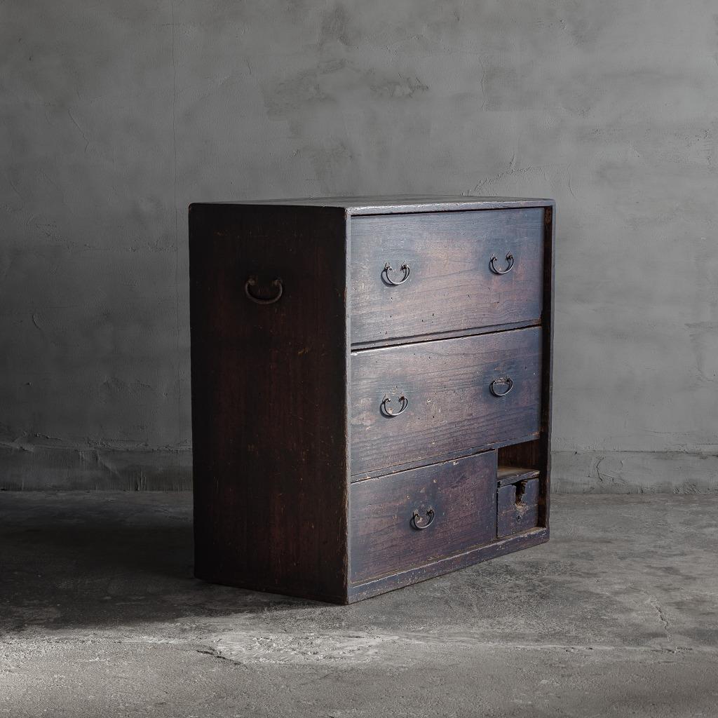 This is a Japanese antique chests of drawers.

This tansu chest is a valuable antique piece made during the late Edo period(Late 1800s) in Japan. Beautiful black surfaces bear the marks of extensive use, exuding a unique history and character.

In