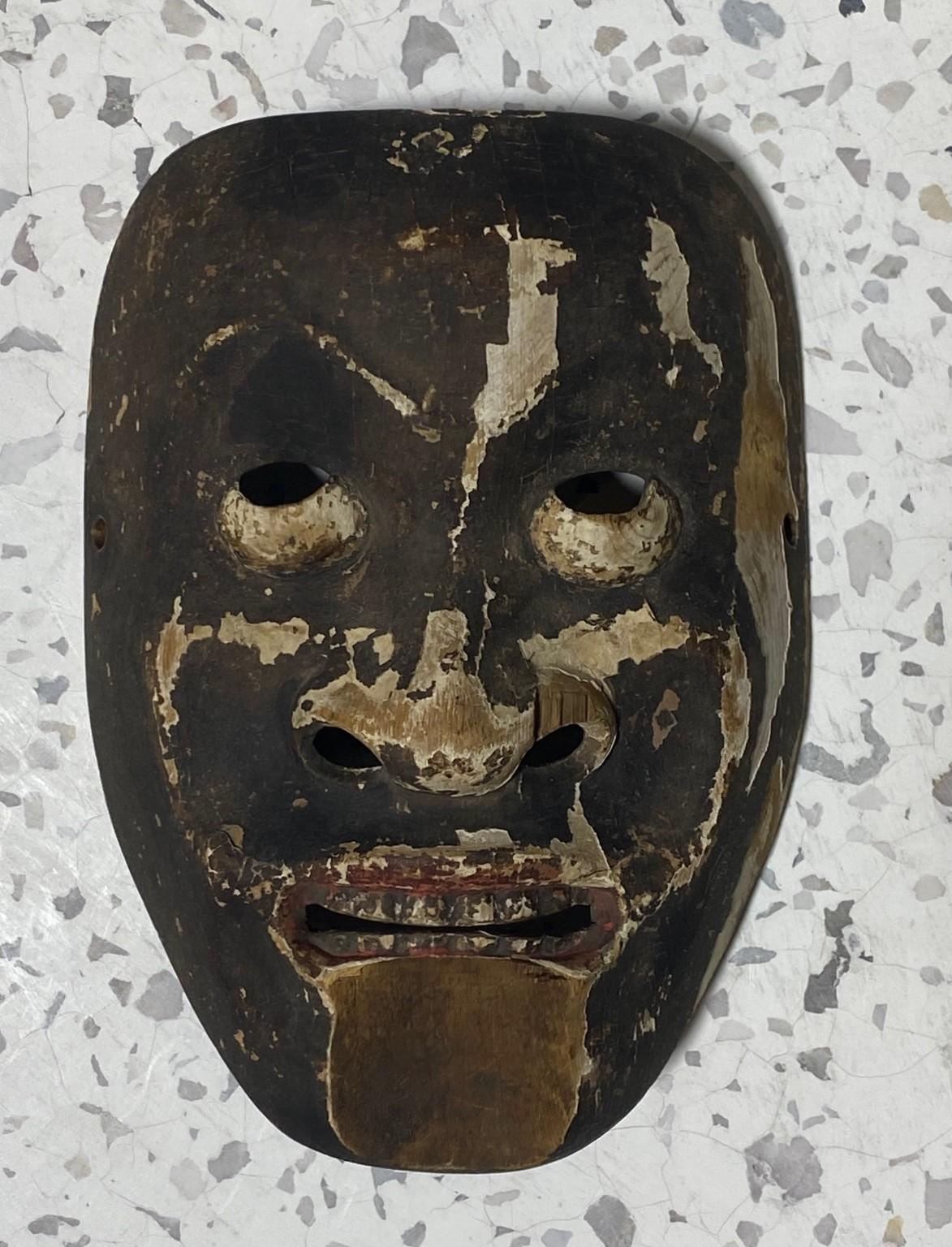 A truly beautiful, wonderfully aged, alluring mask made for Japanese Noh theater. The naturally faded beauty and unique character drew us to this mask immediately. 

The mask is handcrafted and hand-carved from natural wood, clearly by a master of