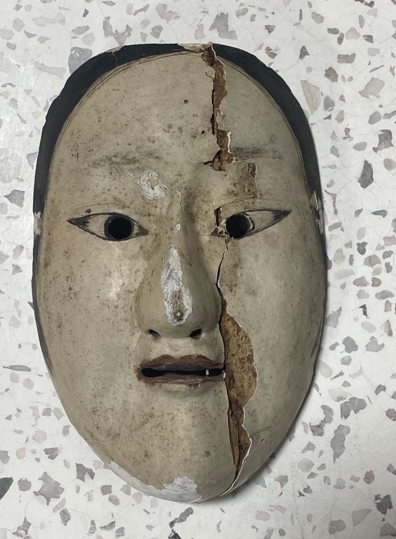 A truly beautiful, wonderfully aged, alluring mask made for Japanese Noh theater. The naturally faded beauty and unique character drew us to this mask immediately. 

The mask is handcrafted and hand-carved from natural wood, clearly by a master of