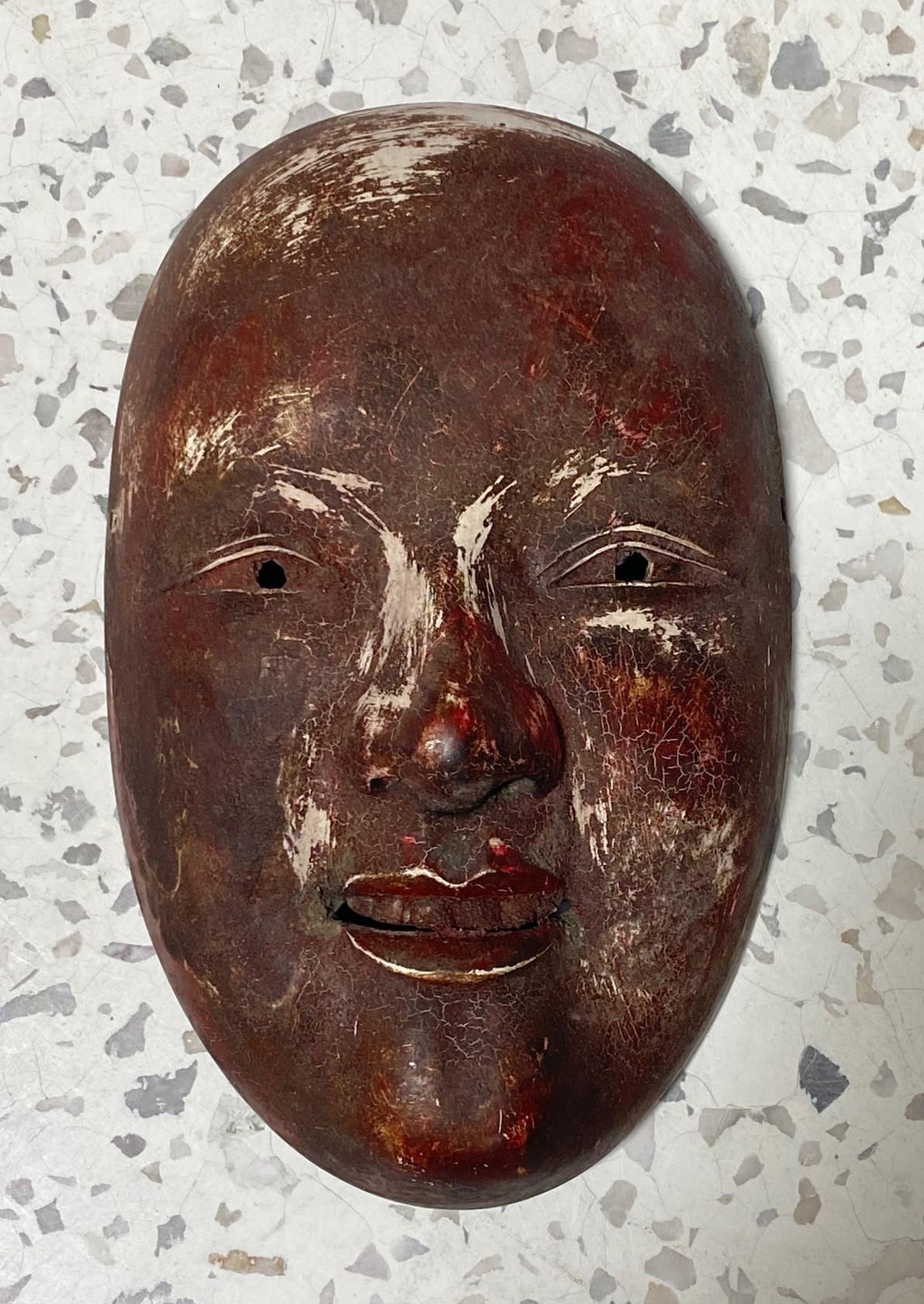 A truly beautiful, wonderfully aged, alluring mask made for Japanese Noh theater. The naturally faded beauty and unique character drew us to this mask immediately. 

The mask is handcrafted and hand-carved from natural wood, clearly by a master of