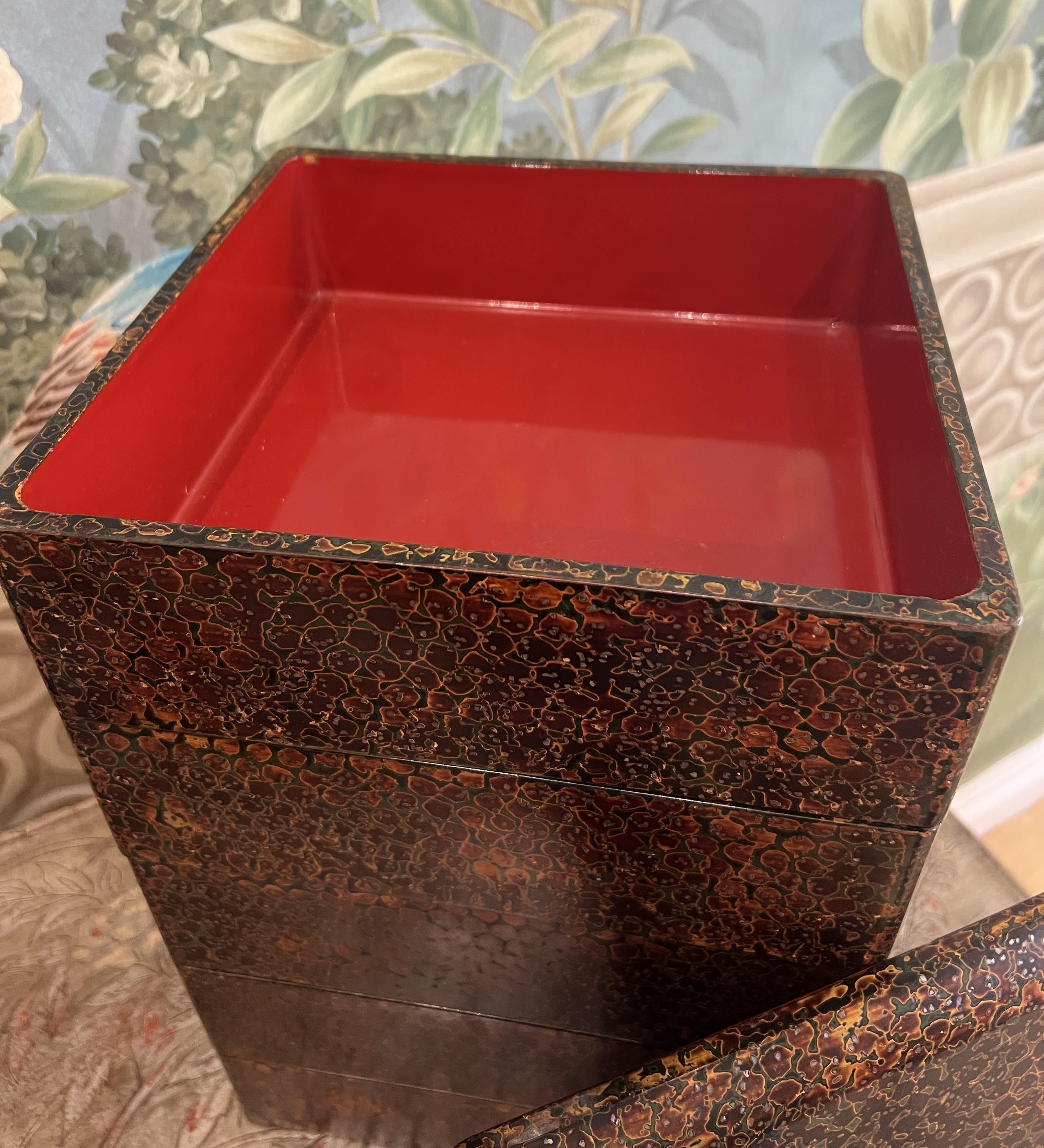 Ancienne boîte à empiler en bois laqué japonais à cinq niveaux, connue sous le nom de jubako. Il est fini avec une technique traditionnelle appelée Tsugaru-nuri, en particulier le motif kara-nuri, qui est connu pour son aspect complexe et moucheté.