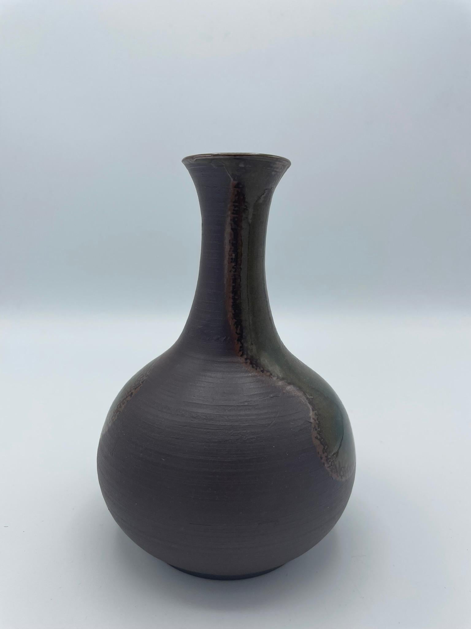 This is a flower vase made around 1970s and with style Tokoname.

Tokoname-yaki (Tokoname ware) is a type of Japanese pottery, stone ware and ceramics, and it is the one of the Six Ancient Kilns of Japan.
Tokoname ware is made in Aichi