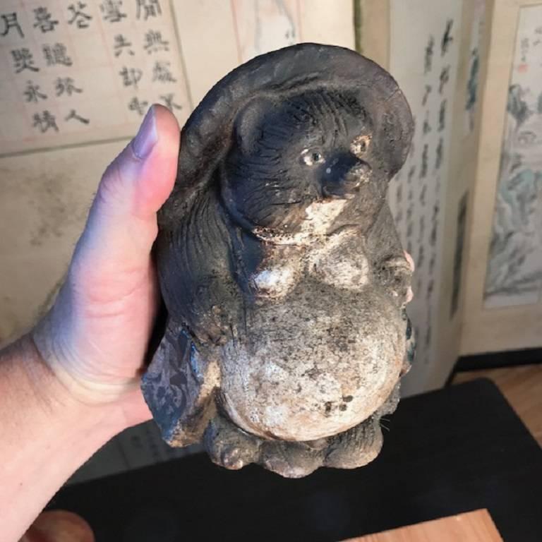An old antique portable scale handmade and hand glazed and big bellied Folk Art Hero Tanuki- raccoon dog ceramic party animal from Japan crafted of heavy duty, thick glazed pottery.

These older examples are hard to find, especially in this