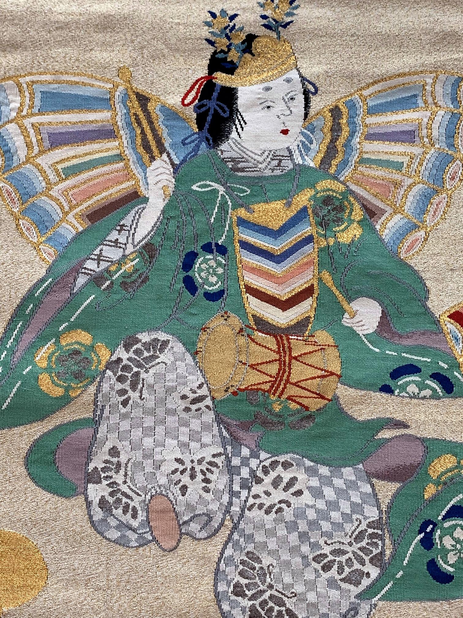A Japanese antique Fukusa textile panel circa late 19th-early 20th century Meiji Period. On the woven tapestry background with gold thread forming clouds and mist, the main composition showcases two butterfly dancers, in embroidery with great