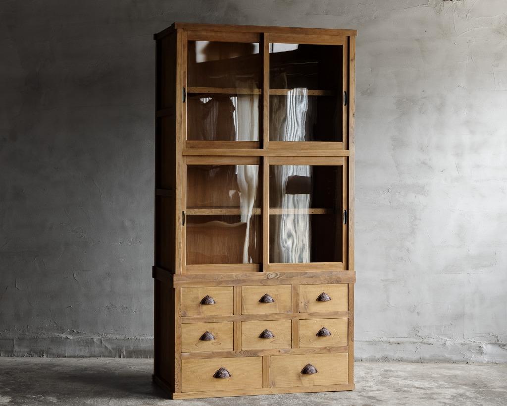 This antique cupboard, crafted during the  early Showa period in Japan.

Crafted using high-quality Japanese cypress and cedar woods, it combines durability with aesthetic appeal. The front features transparent glass sliding doors that elegantly