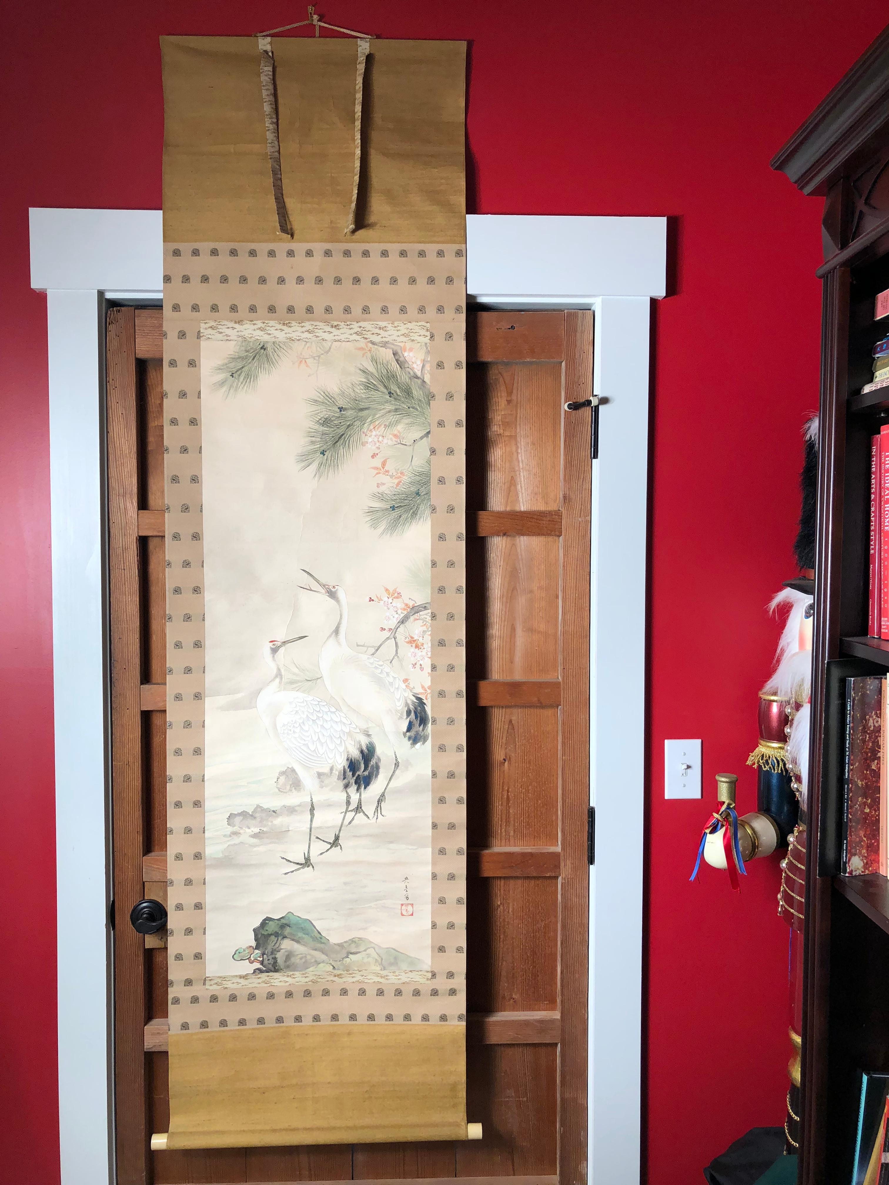 A beautiful antique free hand rendition of a Japanese hand-printed scroll of a conjugal pair of cranes, pine trees and flowering plumb tree, - scroll worthy of your favorite room.

Hand painting on silk in simple classic Japanese striking soft