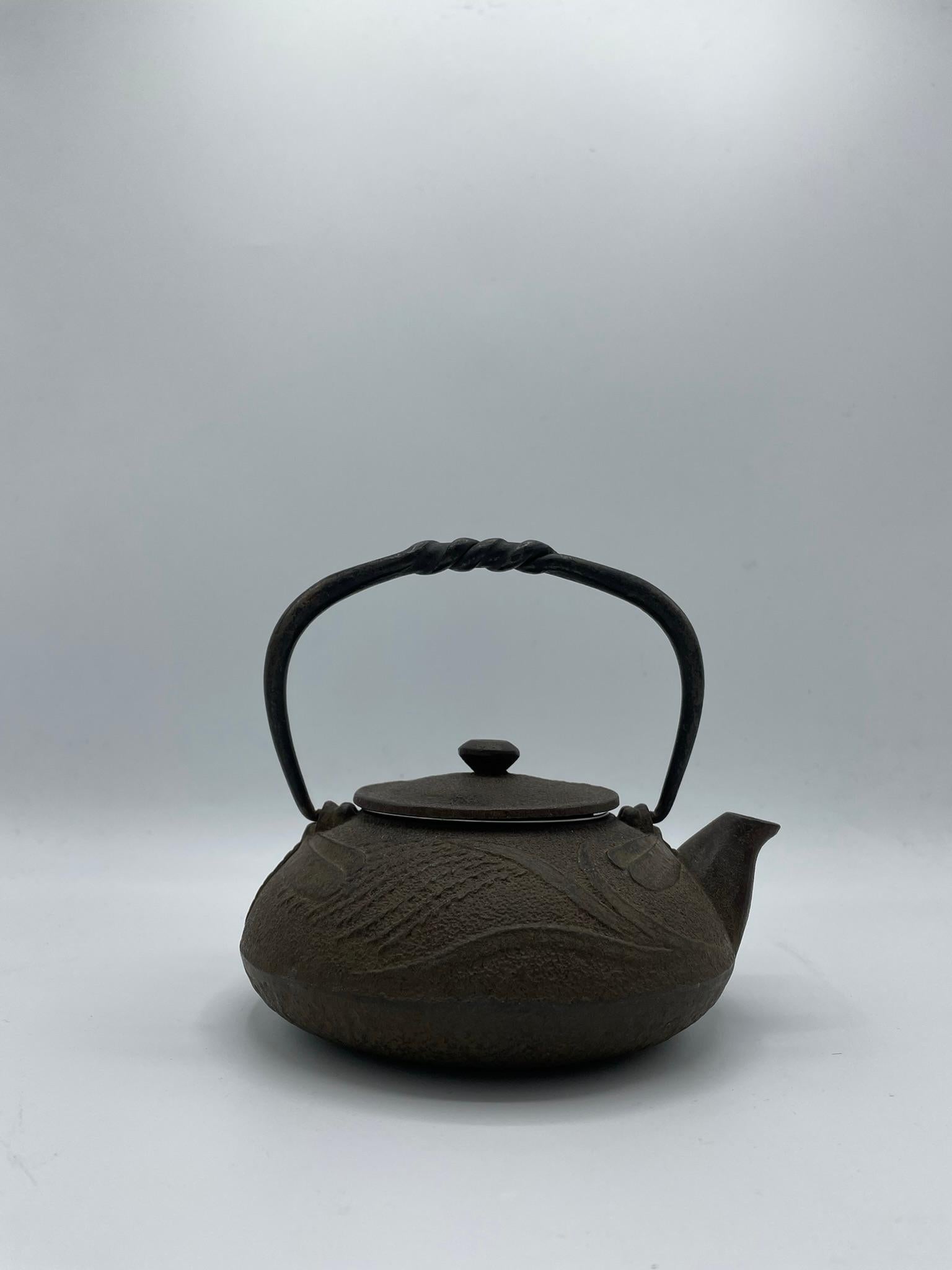 This kettle was made in 1960s, in Showa era. 
The cast iron kettles like this item are called 'Tetsubin' in Japan.
It can be put on the fire or an induction plate. Also we can use it as decoration.
Do not scratch the bottom of the kettle to leave