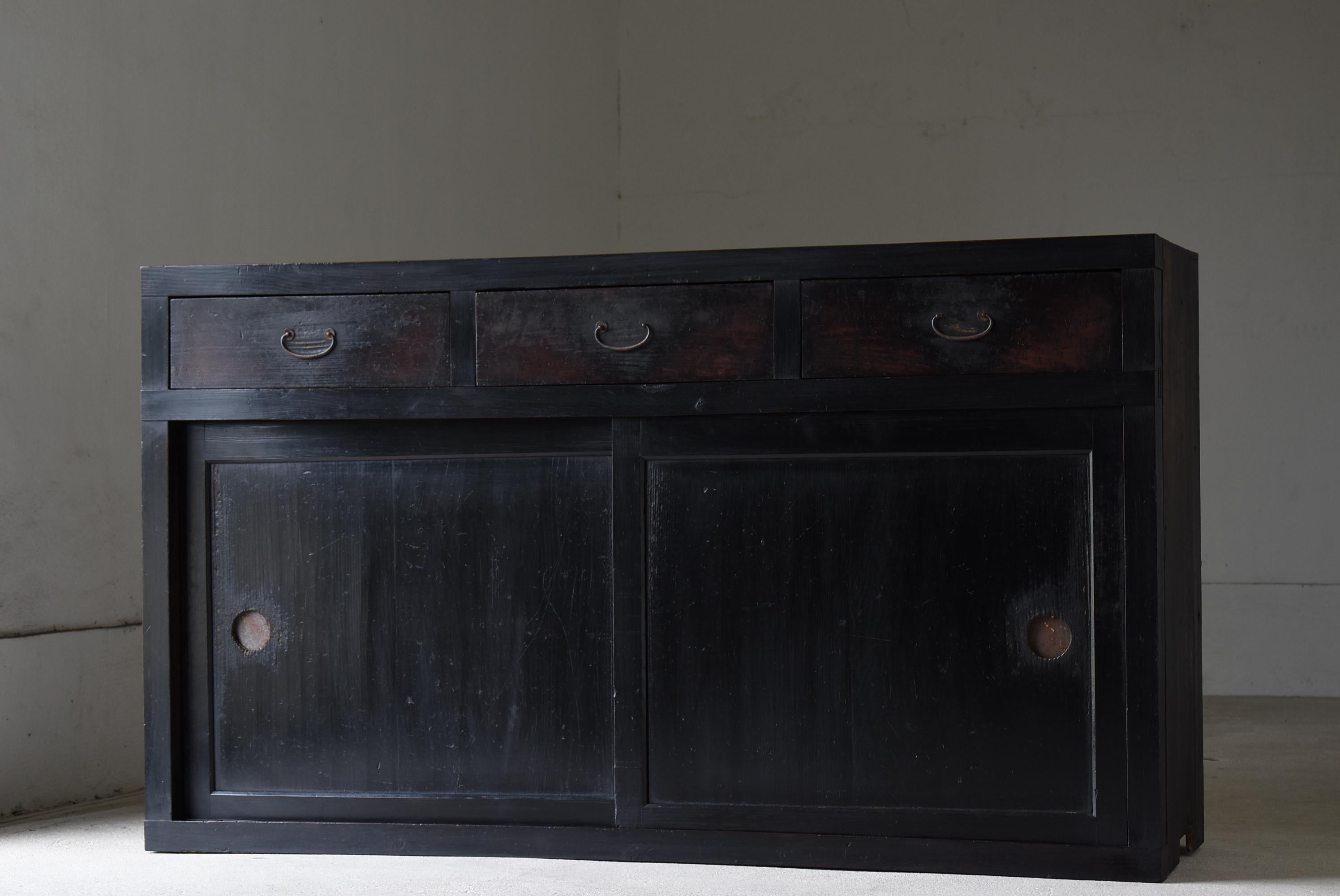 Dies ist ein altes, großes Sideboard aus Japan.
Die Möbel stammen aus der Meiji-Zeit (1860-1900) und sind durchgehend tiefschwarz lackiert, was ihnen ein stattliches Aussehen verleiht.
Das verwendete MATERIAL ist Zedernholz. Die Schubladengriffe