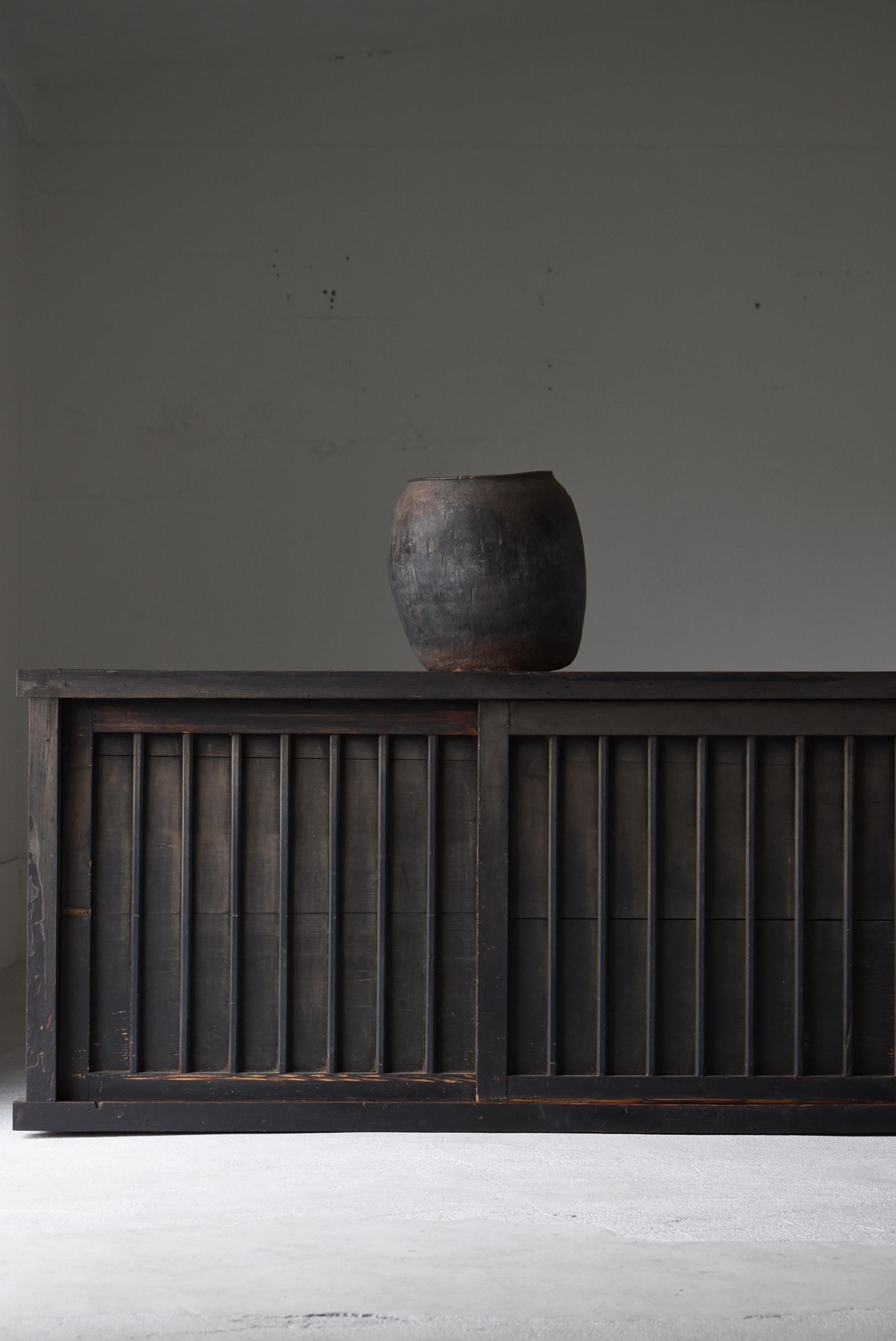 This is an old large black Japanese tansu, crafted during the Meiji period (1860s–1900s). It is made from traditional sugi (Japanese cedar), a material beloved for its warmth and natural character. The piece carries a quiet yet powerful presence,