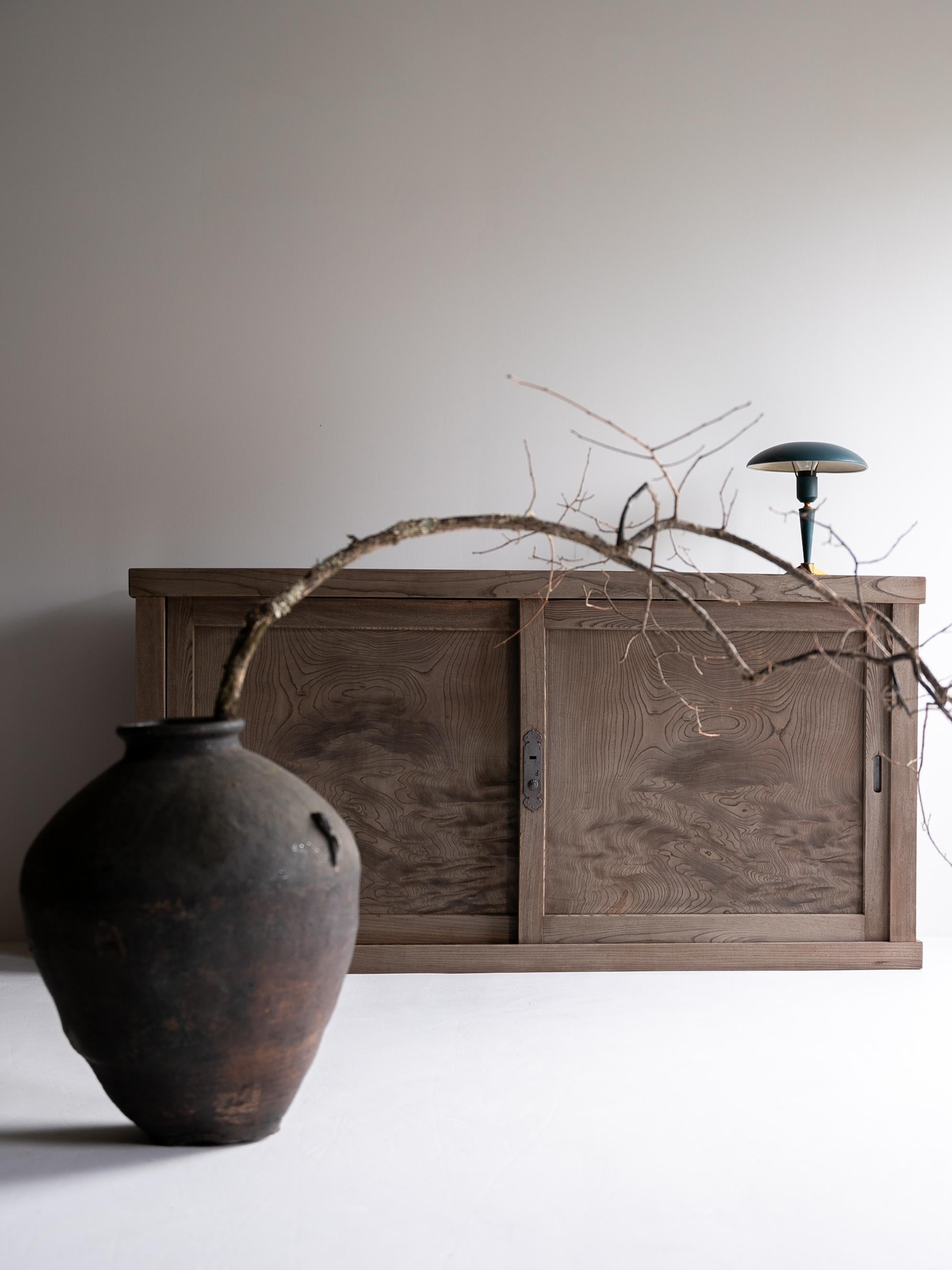 Antico tansu giapponese di grandi dimensioni realizzato in legno di keyaki (zelkova) dalle bellissime venature, risalente al periodo Meiji - Taishō (fine del XIX - inizio del XX secolo).

La forma serena ed equilibrata del mobile incarna l'estetica