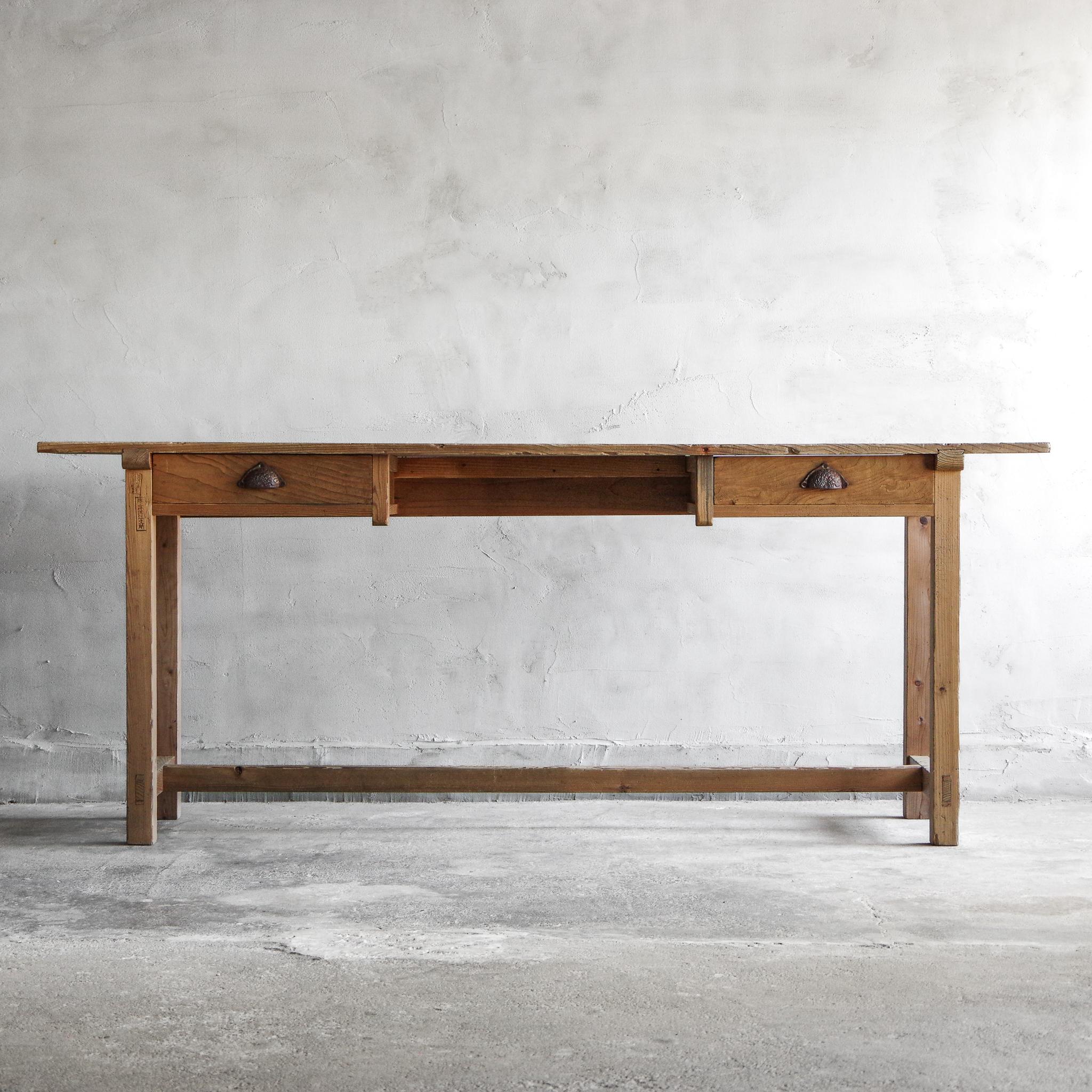 This product is a very old Japanese long desk, blending distinctive design with functional beauty. 
The drawers on each side render this desk a unique and rare find. Made from Japanese cedar, a modest and popular wood, the desk exudes warmth and has