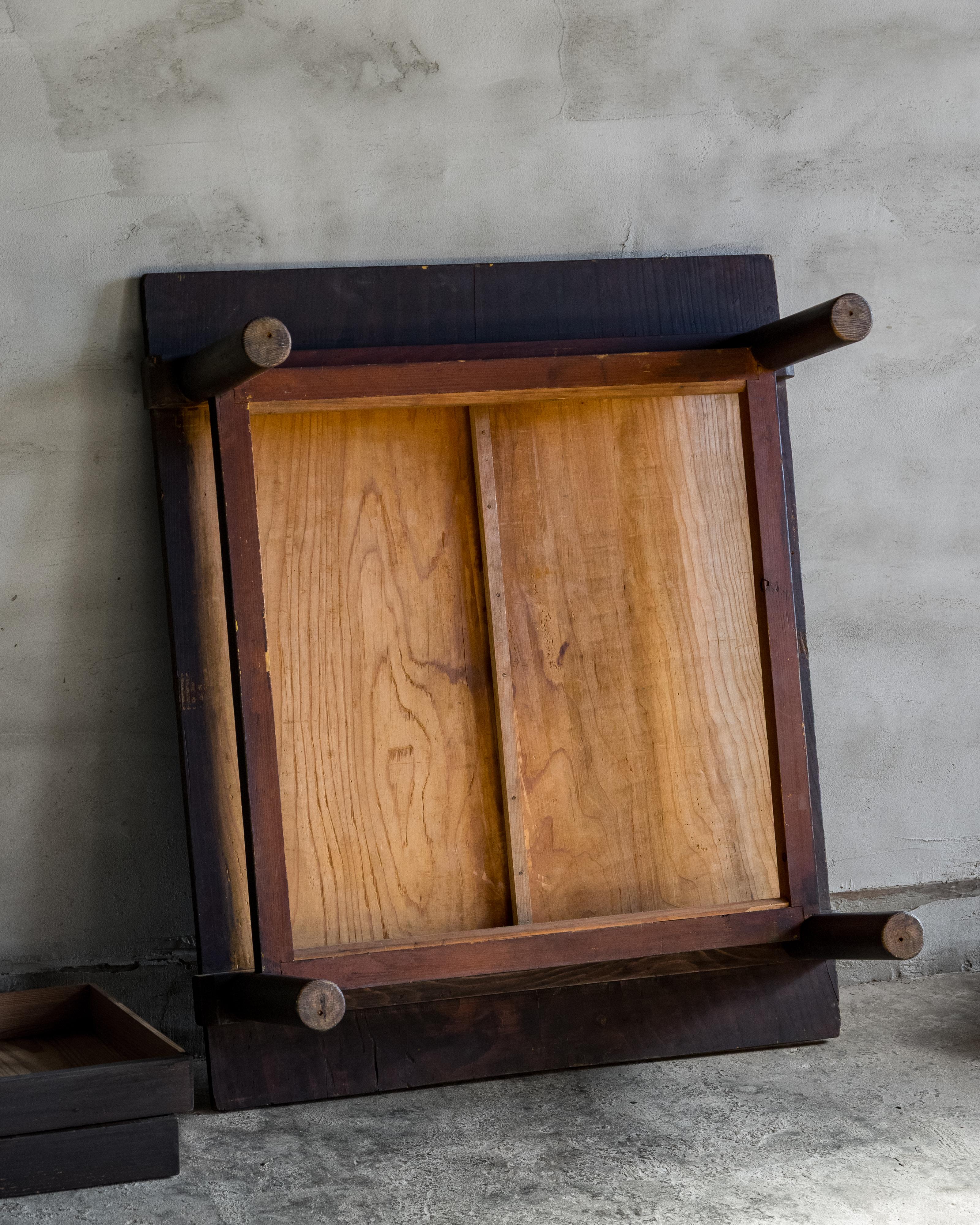 Cette table basse japonaise (zataku) a été fabriquée à l'ère Meiji (1868-1912) en sugi (cèdre japonais) et finie avec du kakishibu (tanin de kaki combiné à de la suie de pin), créant un ton brun profond et chaud qui s'est magnifiquement adouci avec