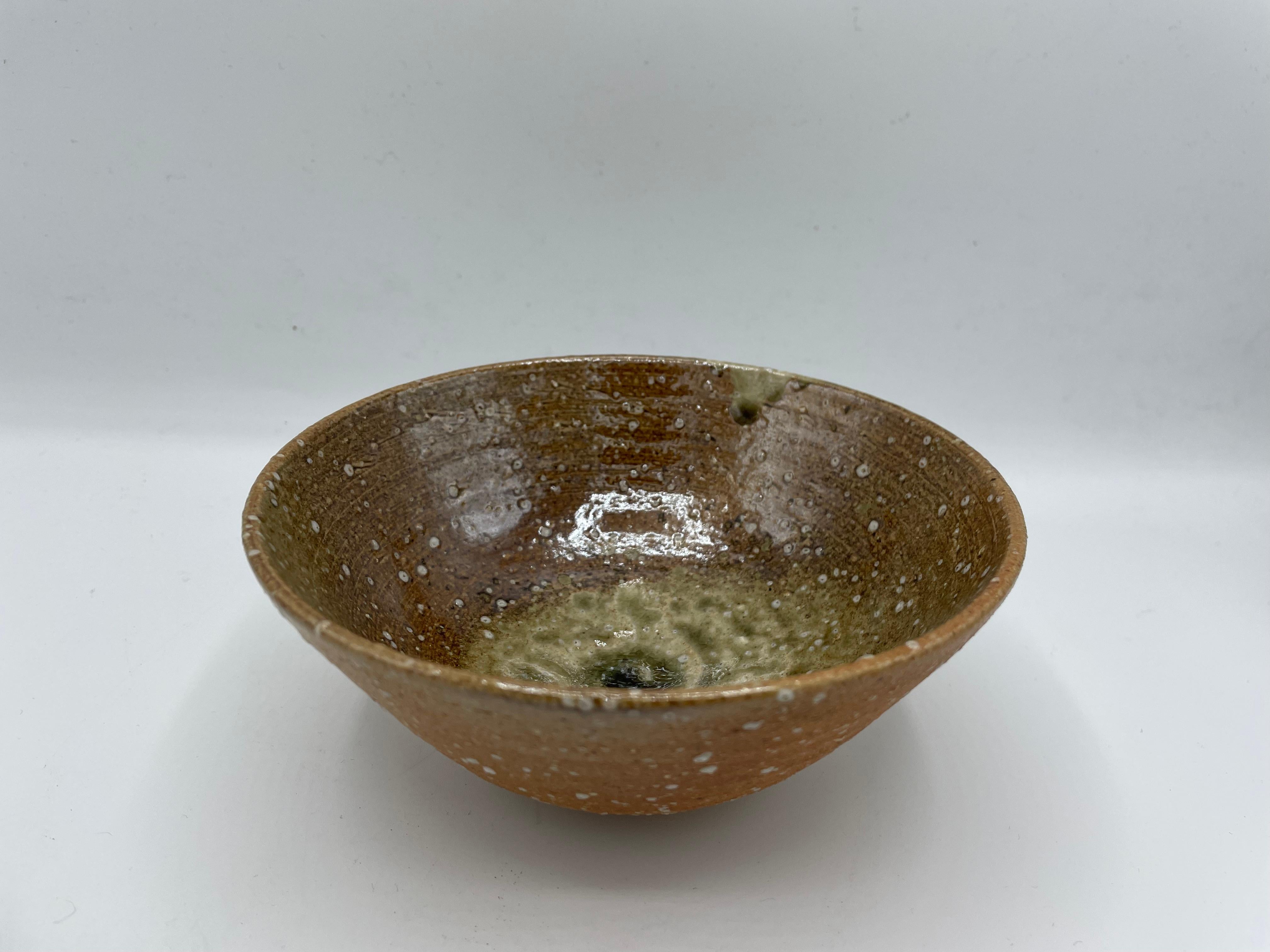 This is a matcha tea bowl which we use for tea ceremony.
This matcha bowl (matchawan in Japanese) was made around 1980s in Showa era.
This is Shigaraki ware and on the bottom of this bowl, it is written 'Rakuhou'.

Dimensions: 14.5 x 14.5 H 6.3