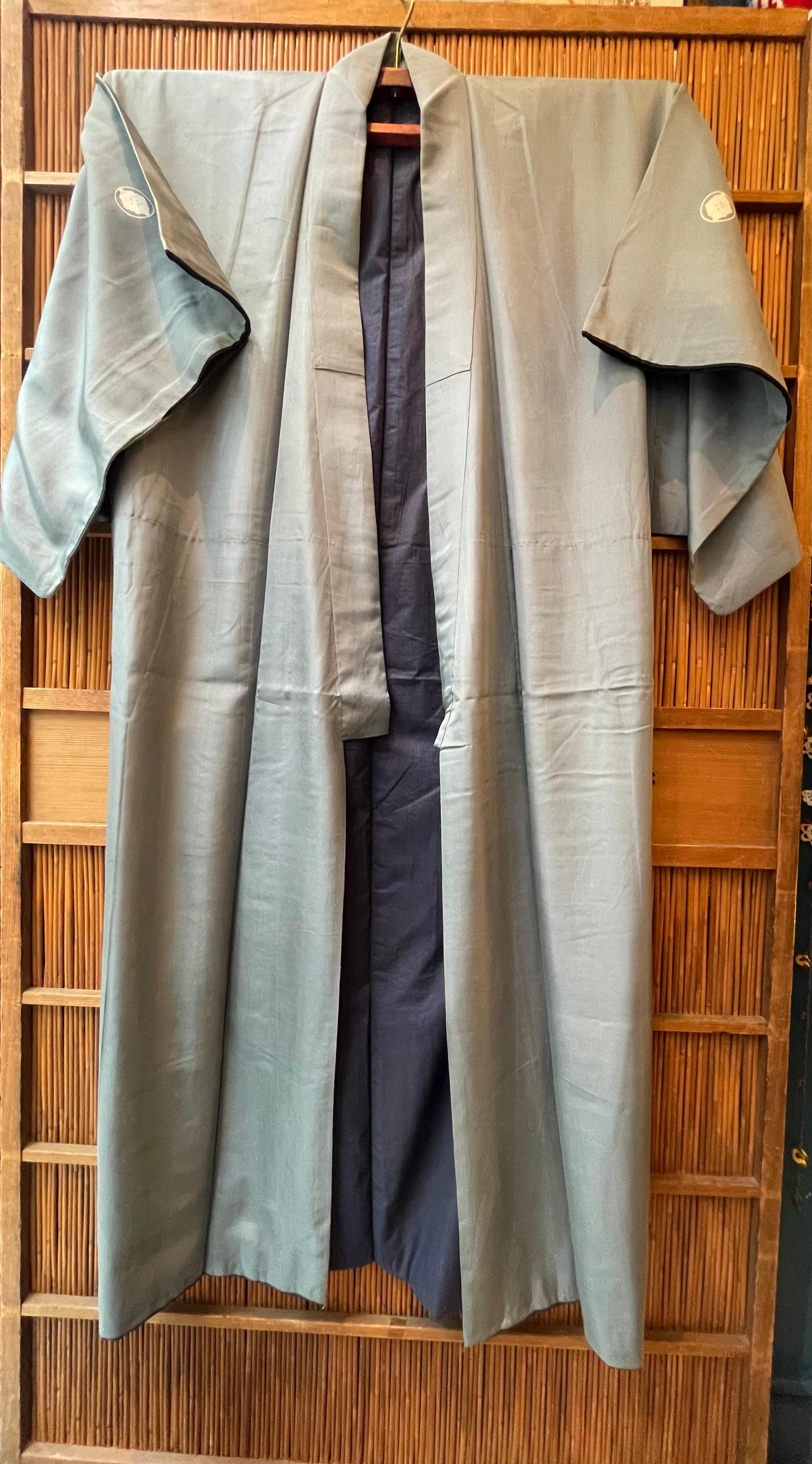 This is a men's silk Kimono. The color outside is sky blue and inside is in dark blue.
It has a family crest called kamon. This kimono has one called 'maruni kenhana bishi', two on the front and one on the back.

Kimono is a traditional Japanese