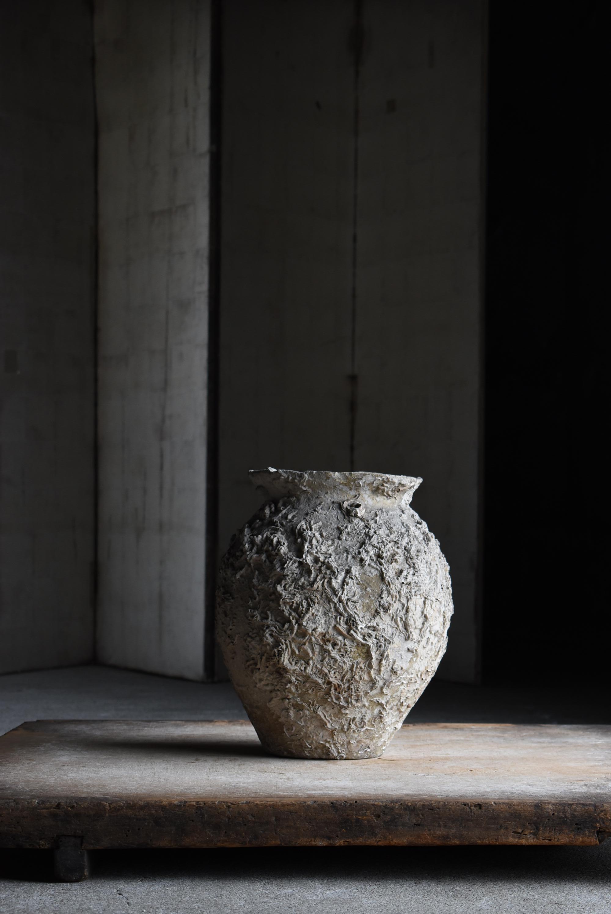 This is a very old unglazed pottery made in Japan.
It is estimated to have been made in the 19th century and was called “Takotsubo” (octopus pot) in Japan, and was used to collect octopus.

Because they were submerged in the sea for many years,