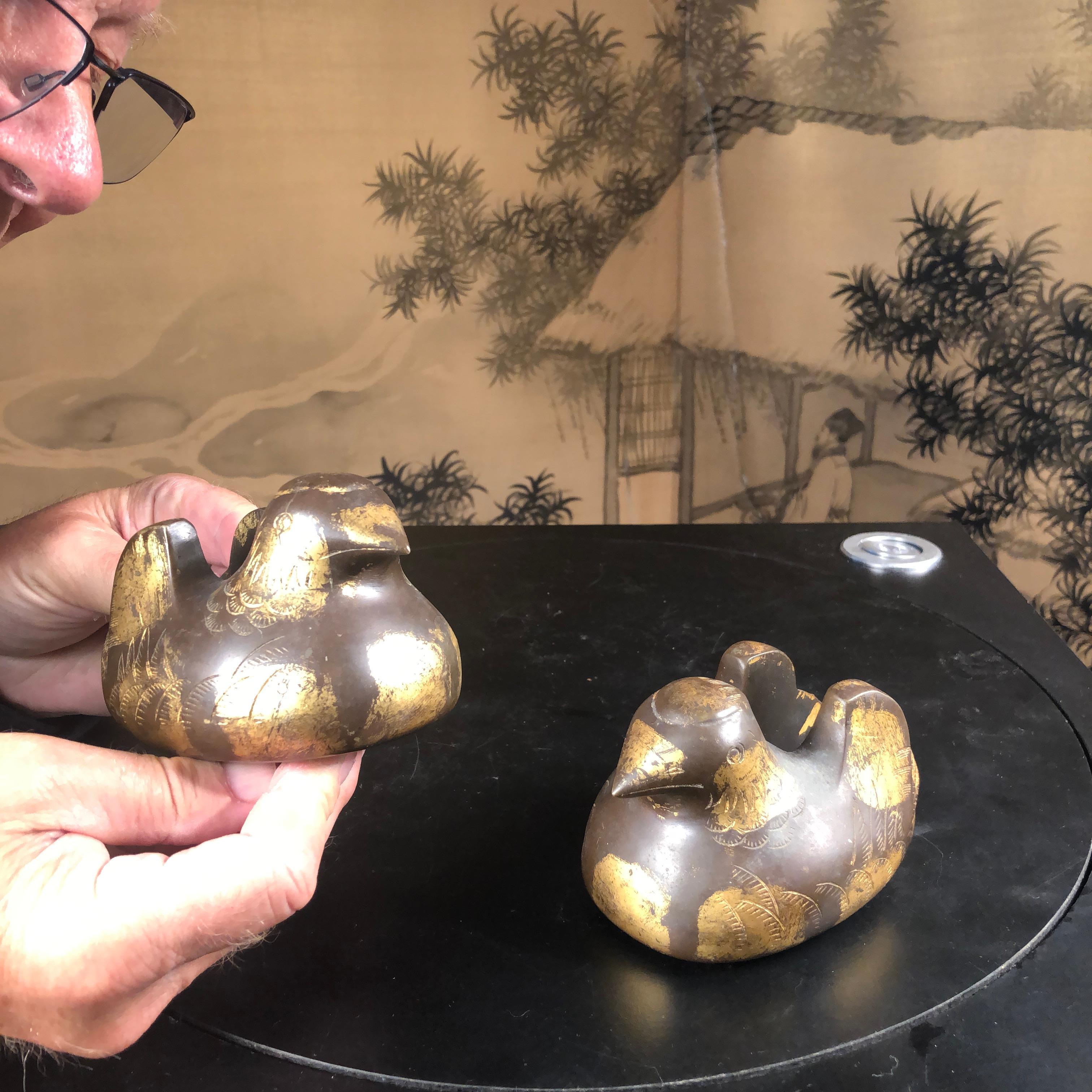 A fine pair of Japanese hand cast gold gilt bronze Mandarin Duck screen holders with highly detailed plumage, late Meiji period 19th century.

Each of these two sculptures are in remarkably very fine condition with much of the original gold