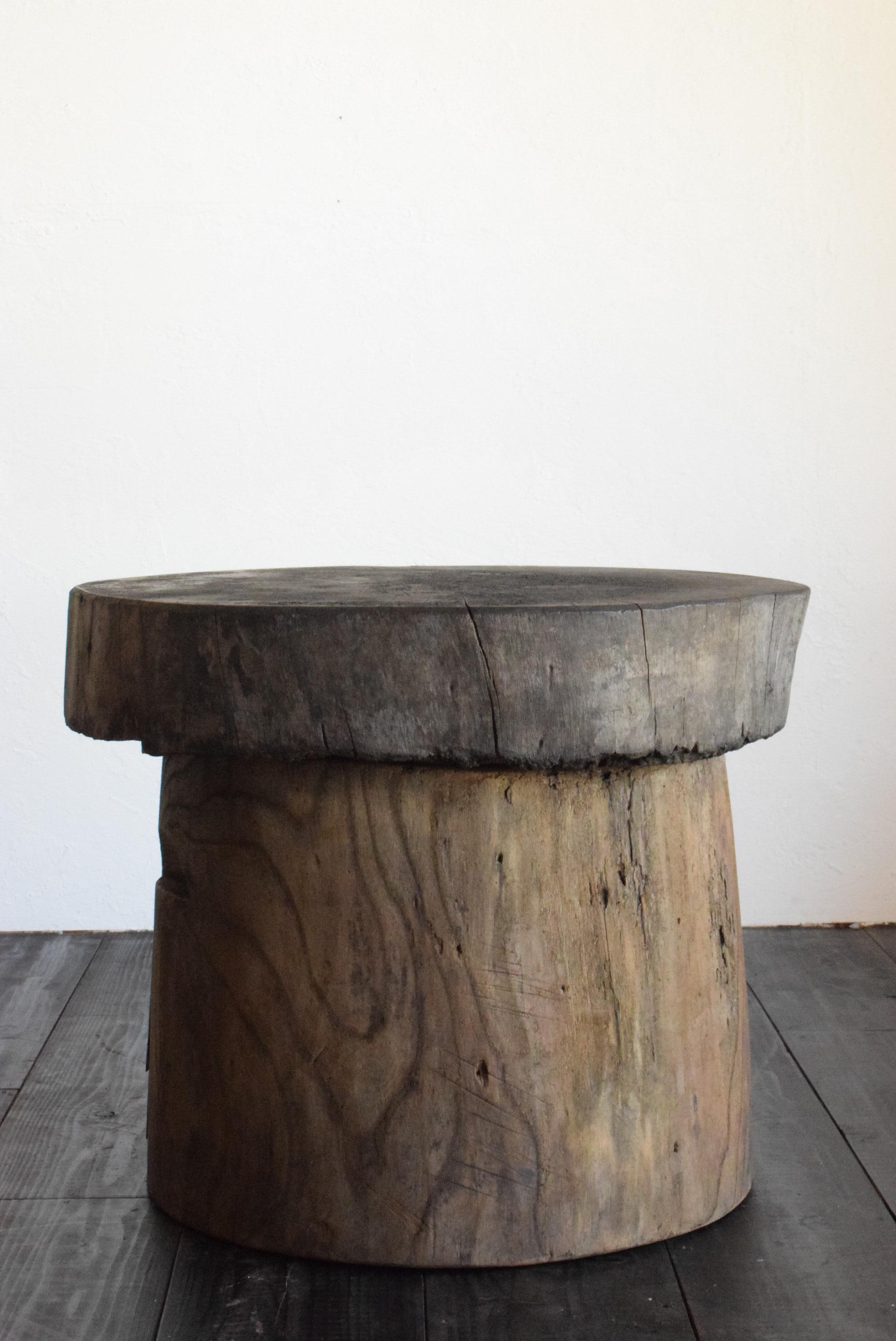 This is a very old Japanese coffee table. It is designed with a wooden board on top of a stump. Both the wooden board and the stump are made of zelkova wood. Both materials are from the Meiji period (1860s-1900s). Each material itself is very rare.