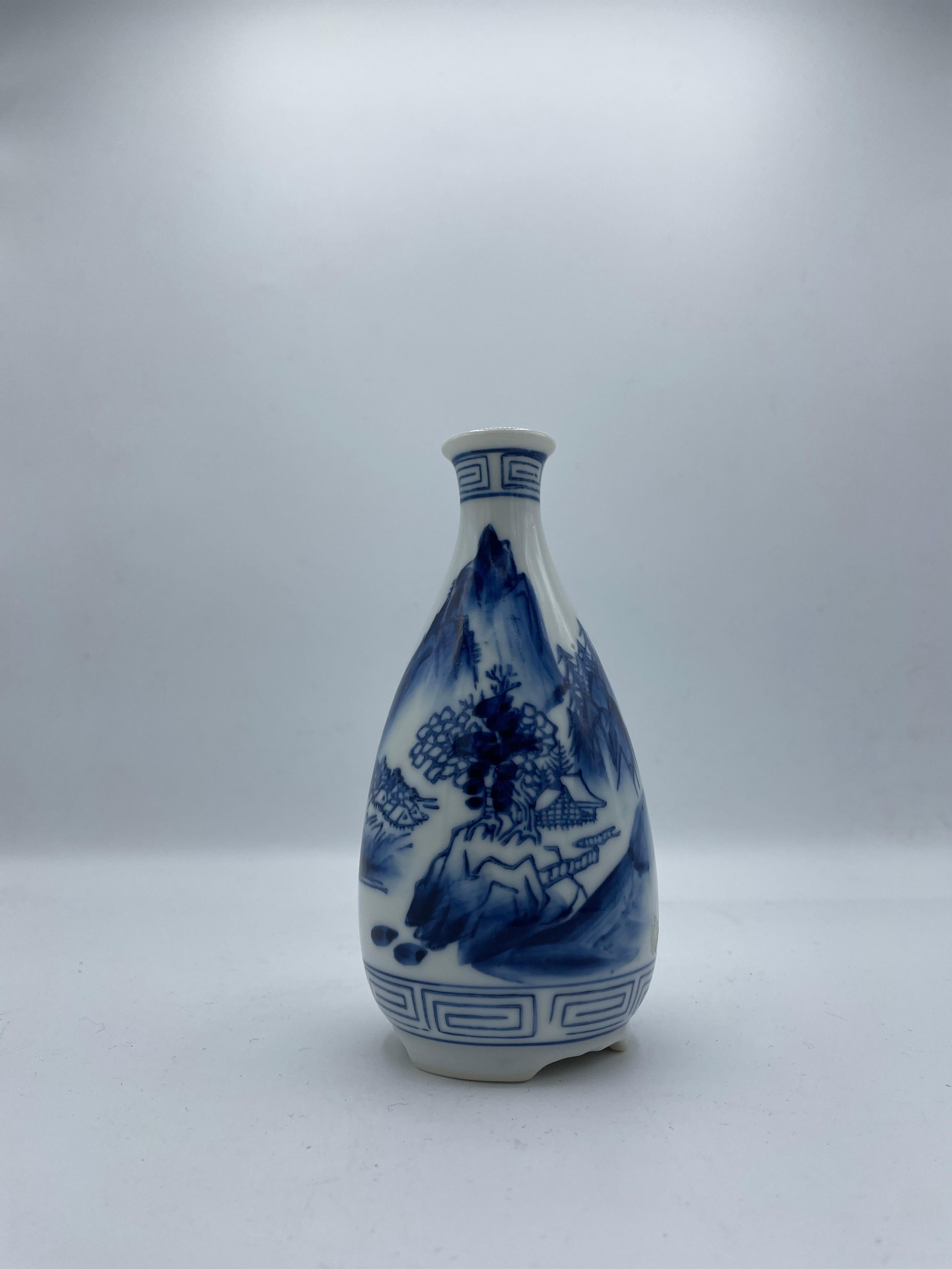 This is a sake bottle which is called 'tokkuri' in Japanese.
This tokkuri is made with porcelain and it is hand painted.
It was made in Showa era around 1940s.
The design is the landscape of Japanese mountain and the house.

Dimensions:
5 x 5 x H15