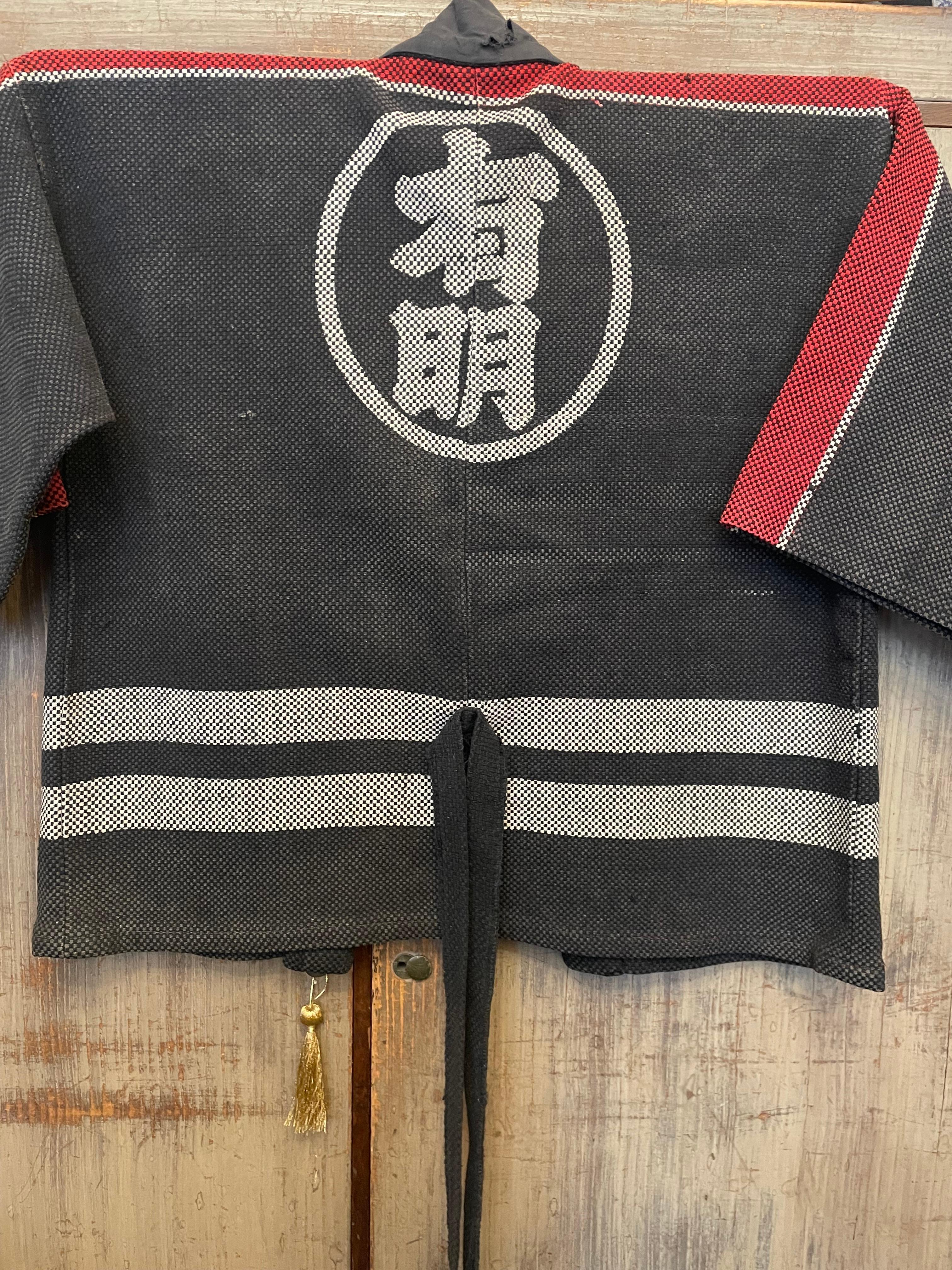This Sashiko b(h)anten was made around 1960 in Showa era in Japan. 
On the front, it is written 'Member of Vigilance Committee Ariake ' in Japanese. On the back, it is written 'ariake' which means a town name in Tokyo prefecture.
This sashiko banten