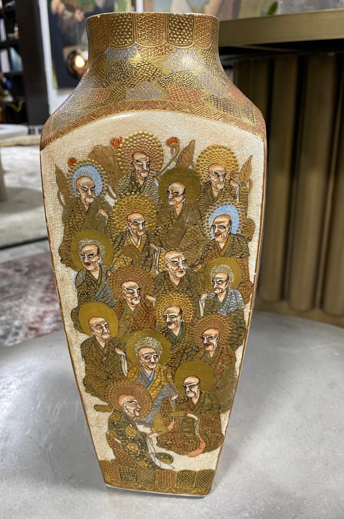 A beautiful Japanese Satsuma pottery studio vase featuring multiple kesa-clad enlightened Buddhist monks on each side of the vase. The piece is finely detailed with rich raised gilt highlights throughout and beautifully decorated in gold and various
