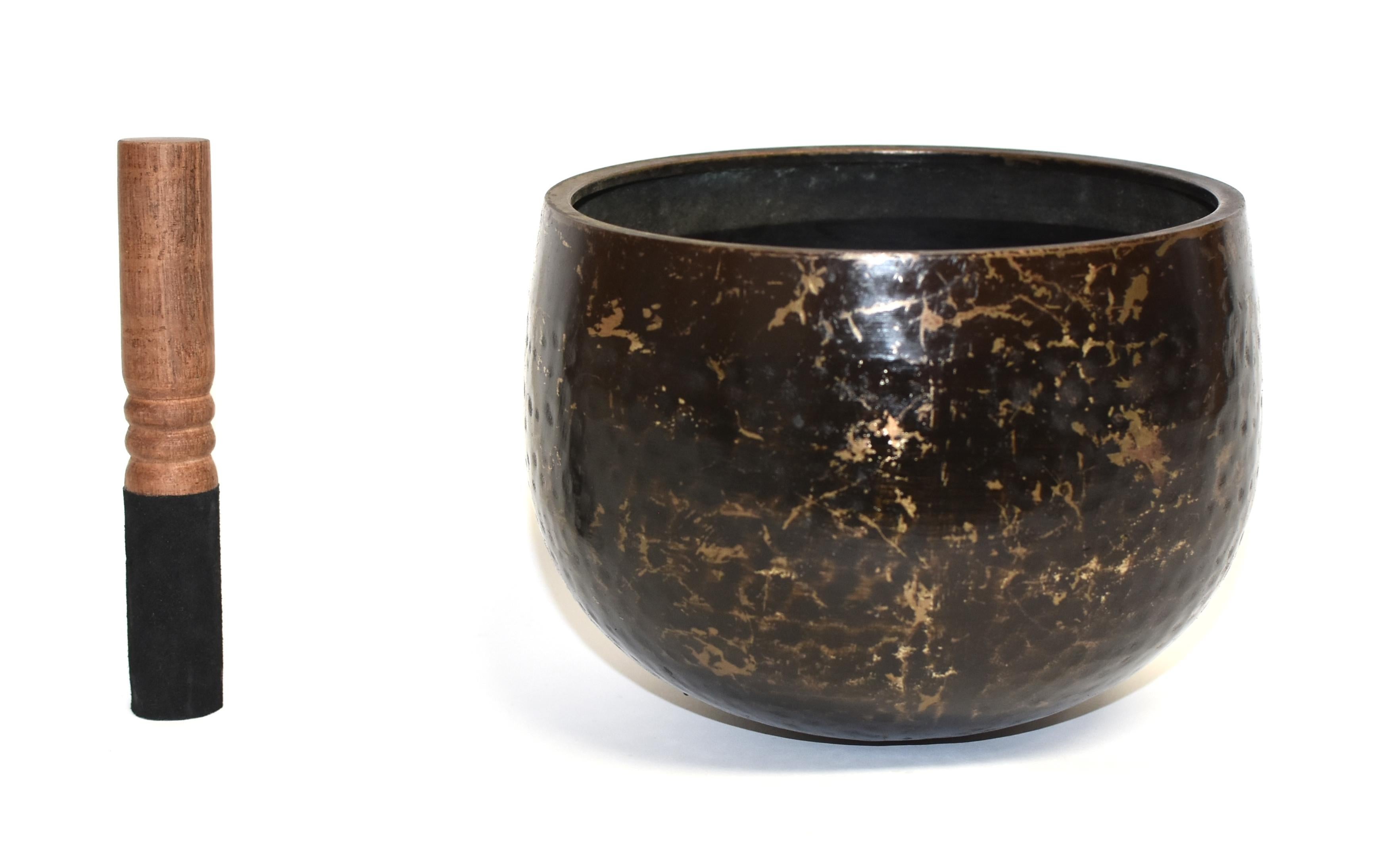 A large, substantial, handcrafted singing bowl made of solid bronze with hand-hammered beehive pattern. This bowl makes a beautiful, enlightening sound that is at once soothing and thought provoking. Such a bowl was used in the Japanese temple to