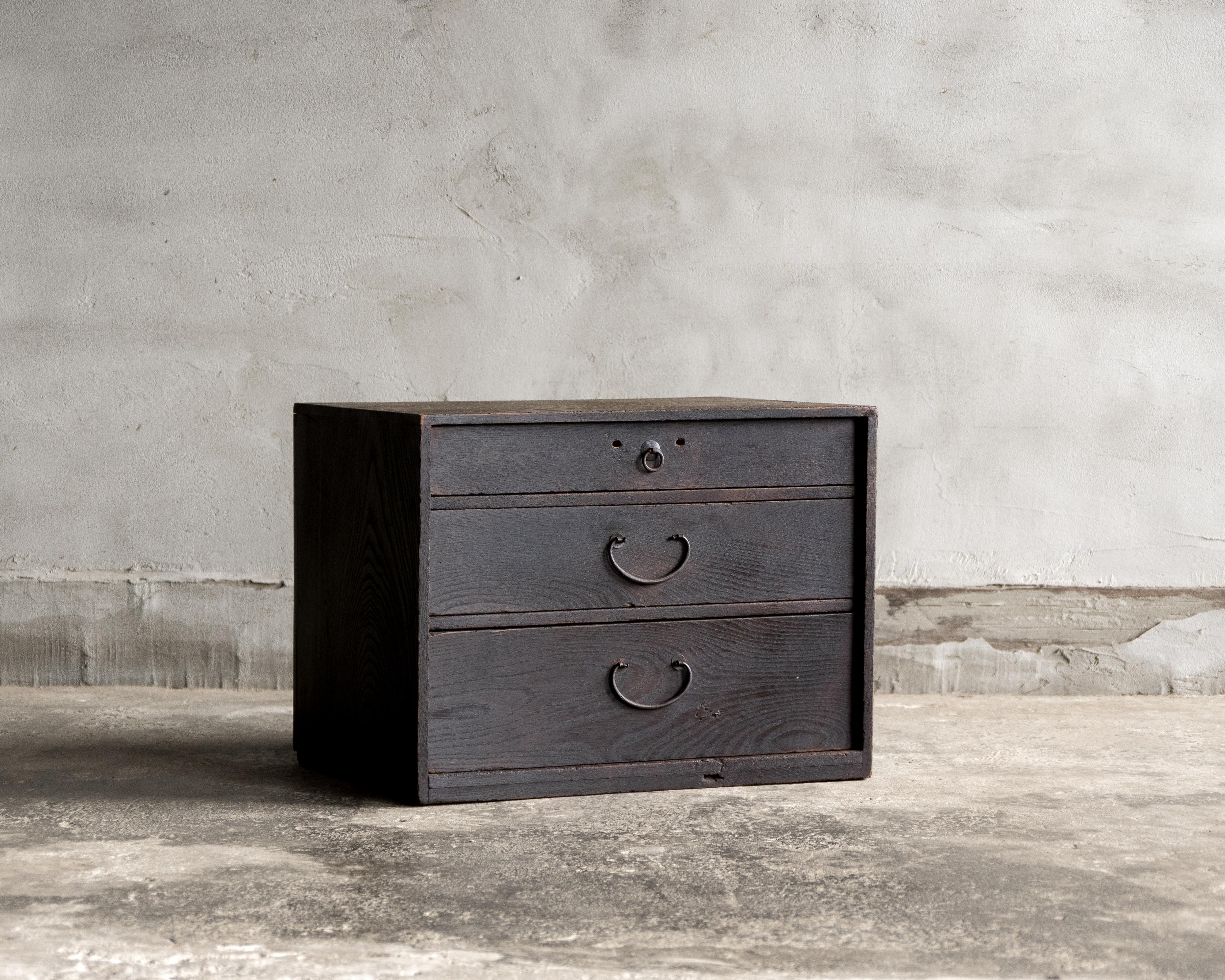 Questa piccola cassettiera antica è stata realizzata in epoca Meiji (1868-1912) con legno keyaki (zelkova) giapponese, rifinito con Urushi (lacca tradizionale giapponese).

Questa cassettiera compatta a tre cassetti è realizzata in keyaki, un