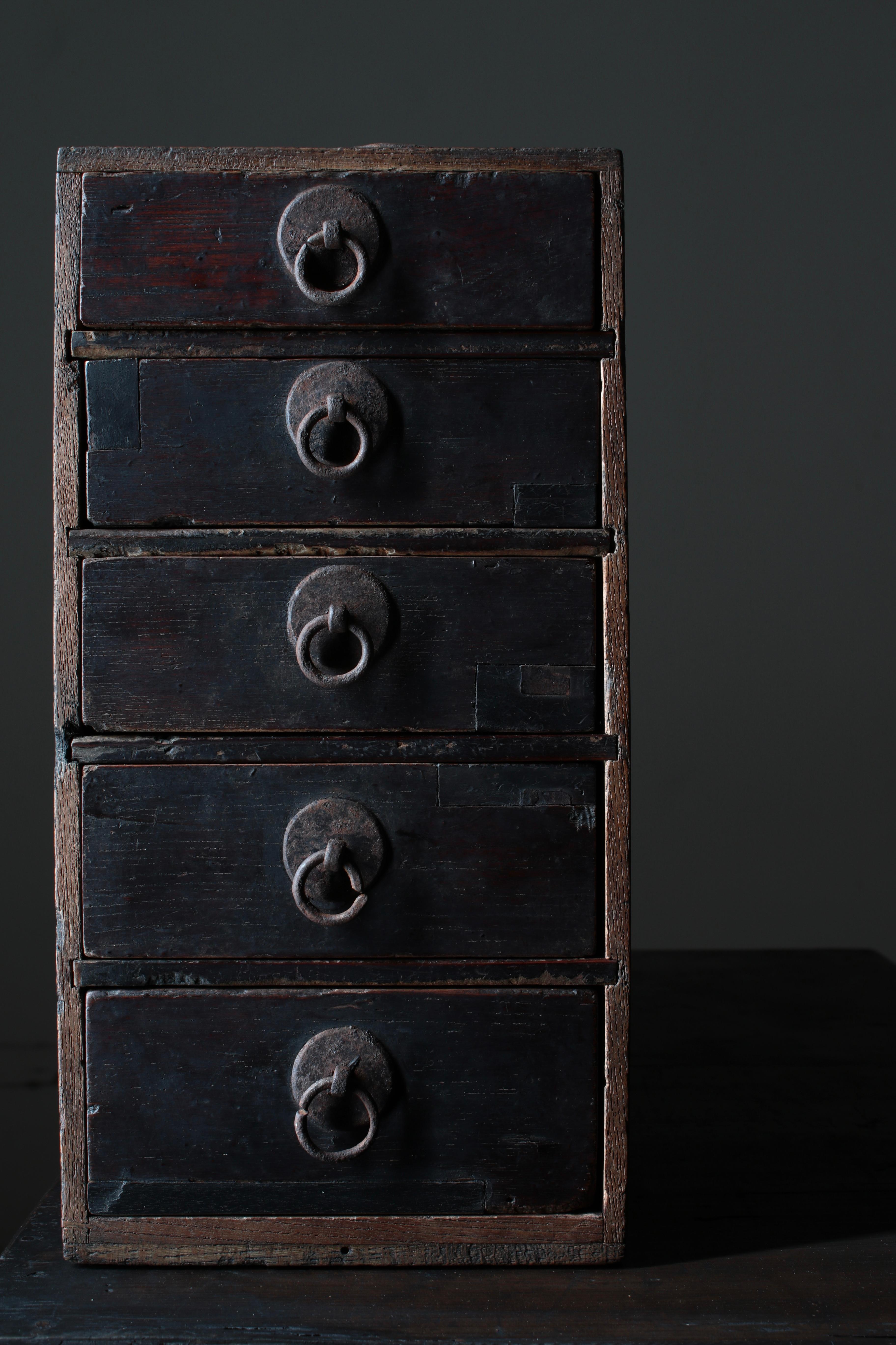 This is an old Japanese small drawer.

It seems to be around the Meiji period, and the material is made of zelkova.

There are 5 drawers, and the size gets bigger as you go from top to bottom.

It is convenient to place on a table or shelf and store