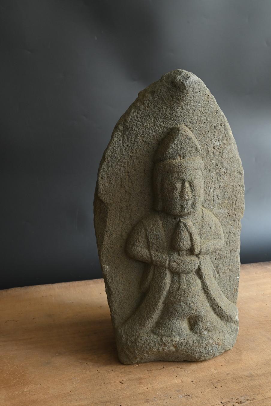 This stone Buddha statue is thought to have been created during the Tenmei era (circa 1781-1789) in Japan's mid-Edo period. Although difficult to read, the characters 