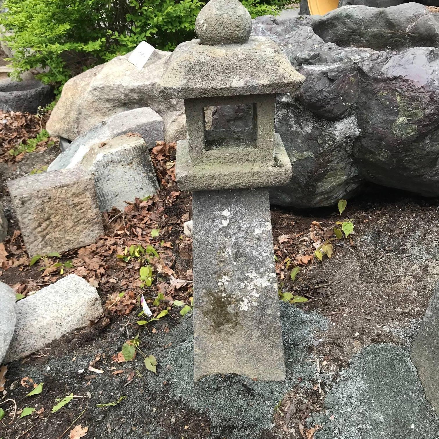 Japan, a fine pathway stone lantern with original and beautiful lichen and patina from great age, 28 inches high.

They work especially well at night with an oil candle. See our photo.
Upon request, we will include one complimentary bottle to get