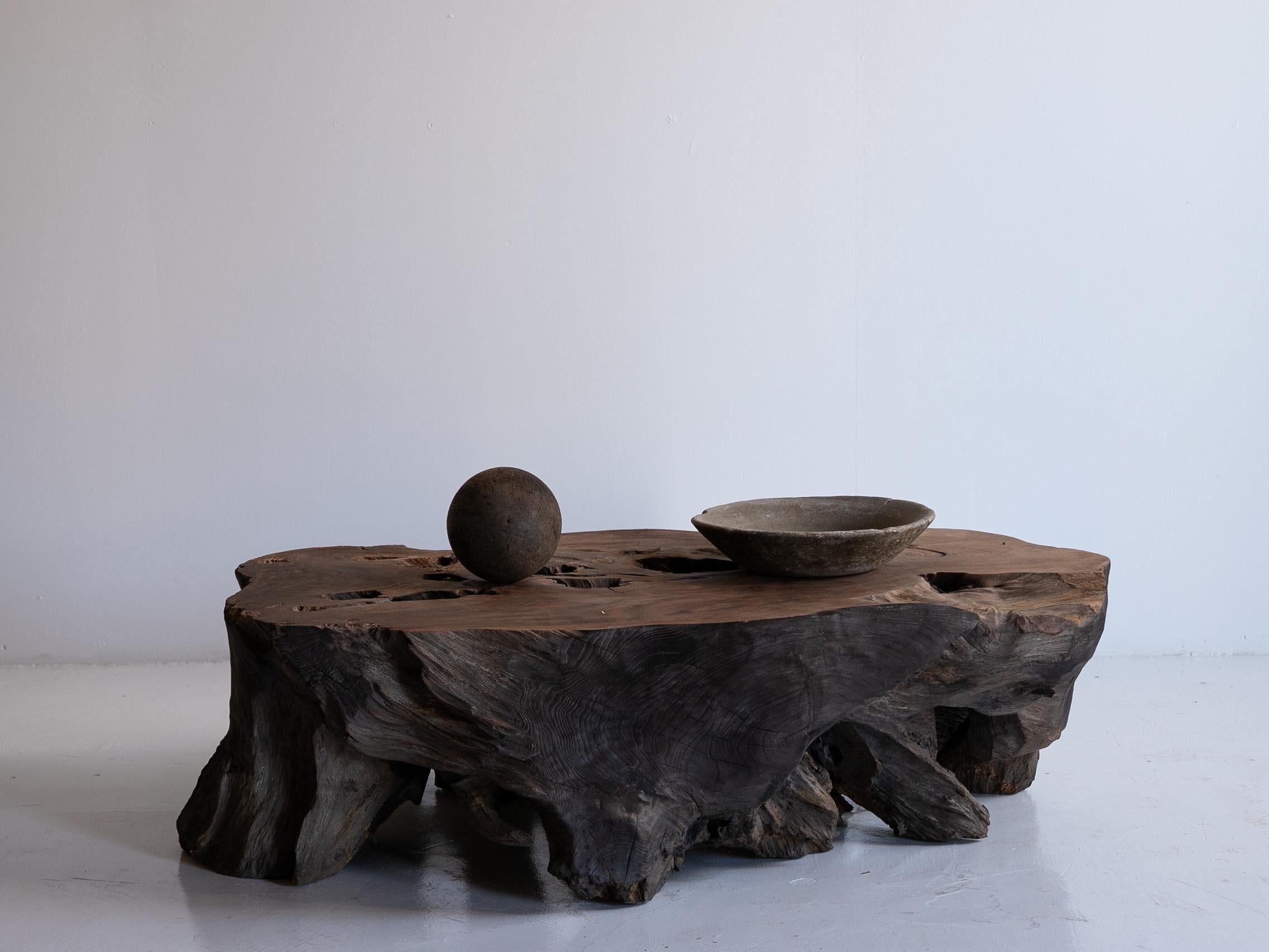 This is a very old wooden root table made in Japan. It dates back to the Meiji period (1860s–1920s) and is made of zelkova wood.

The table showcases the raw power of natural wood, something that cannot be artificially replicated. Its organic form