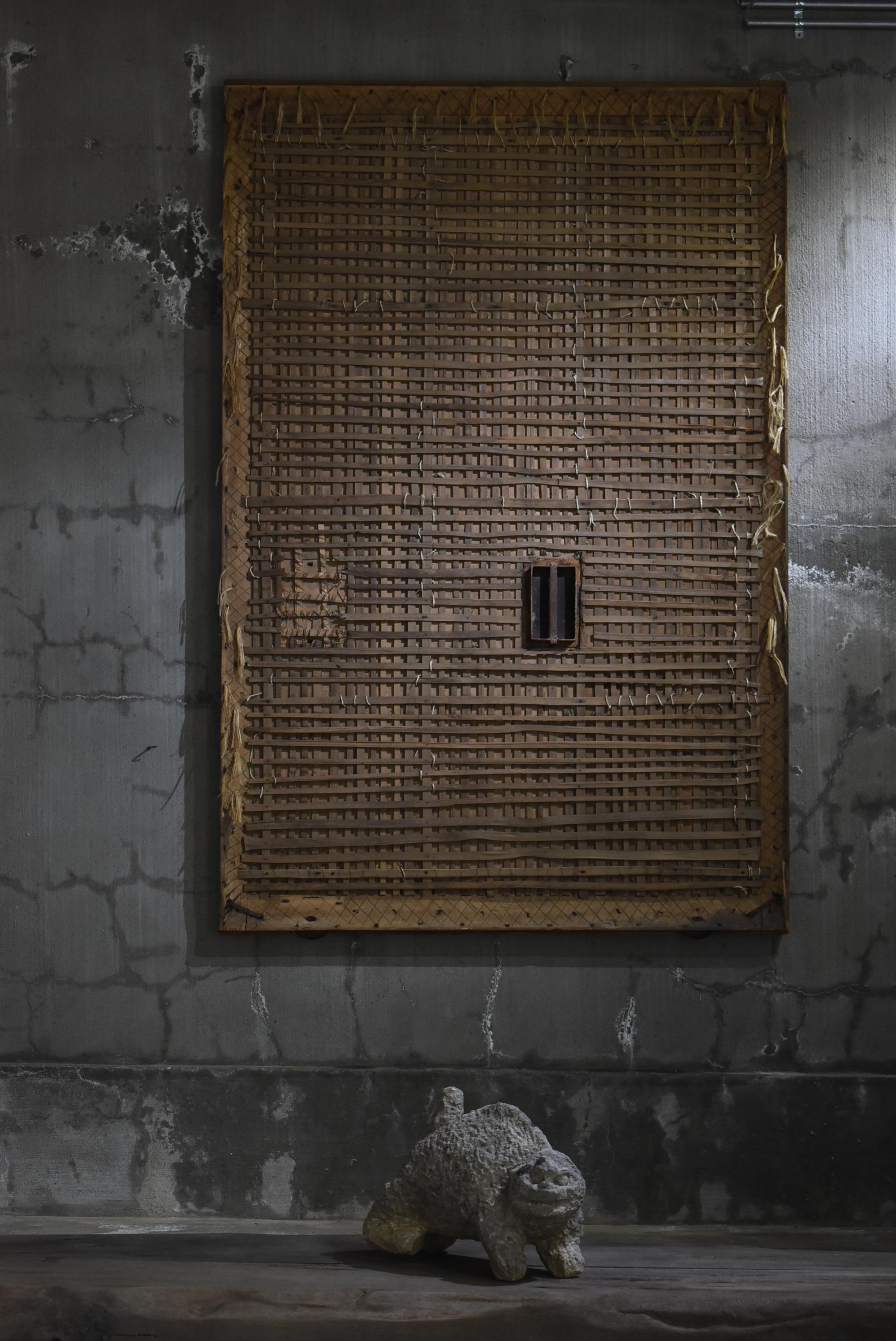 This is a huge door from a very old Japanese warehouse (kura).
This door was made in the Meiji era. (1860s-1900s).
It is mainly made of cedar wood with iron handles.

The door was made of plaster and earth, but the plaster has peeled away to