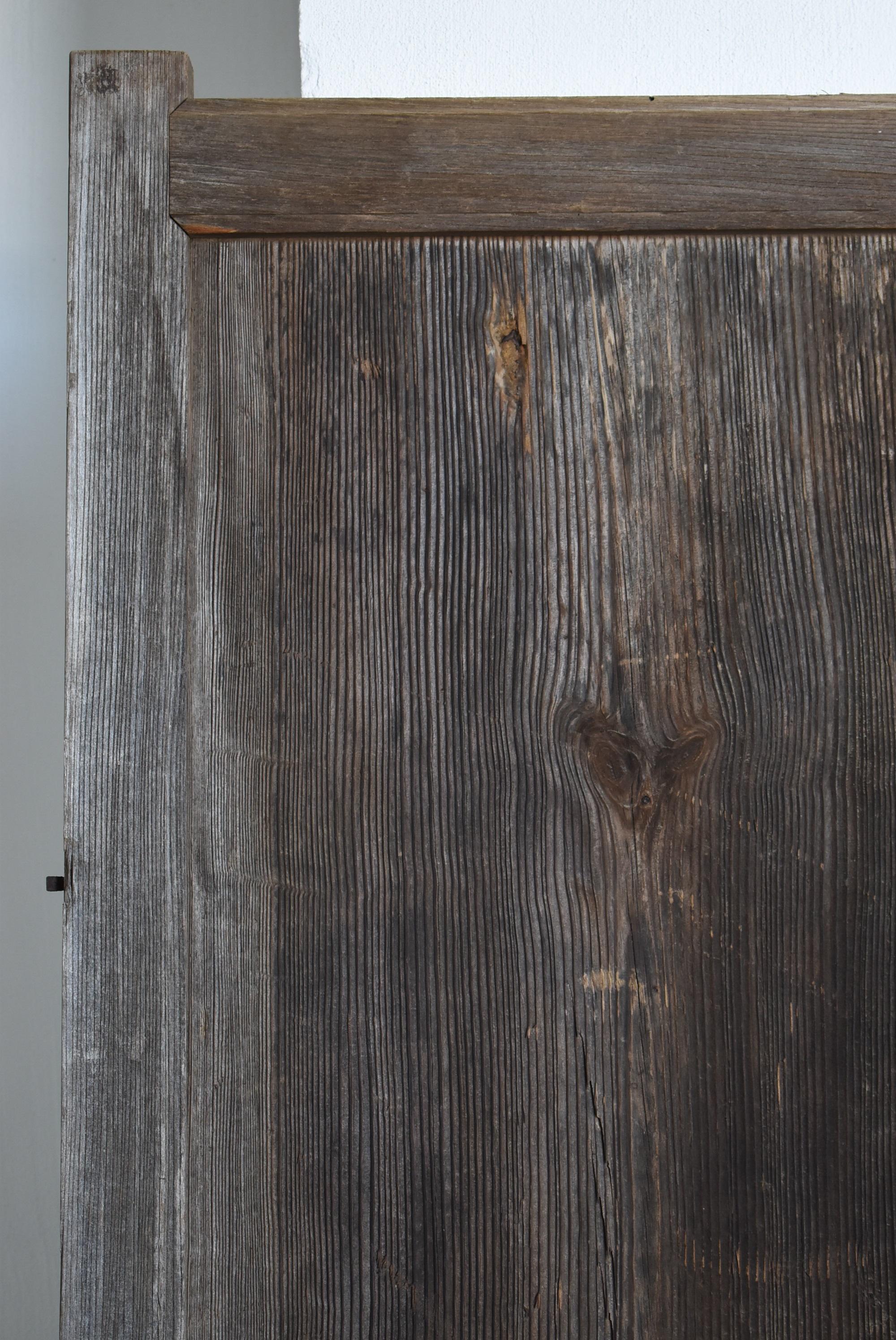 It is the door of the warehouse (KURA) in the Edo period in Japan.
This door is from the late Edo period. (1750s-1860s)

It has been exposed to the wind and rain for a long time, and a very beautiful grain of wood has emerged.
It's just like an