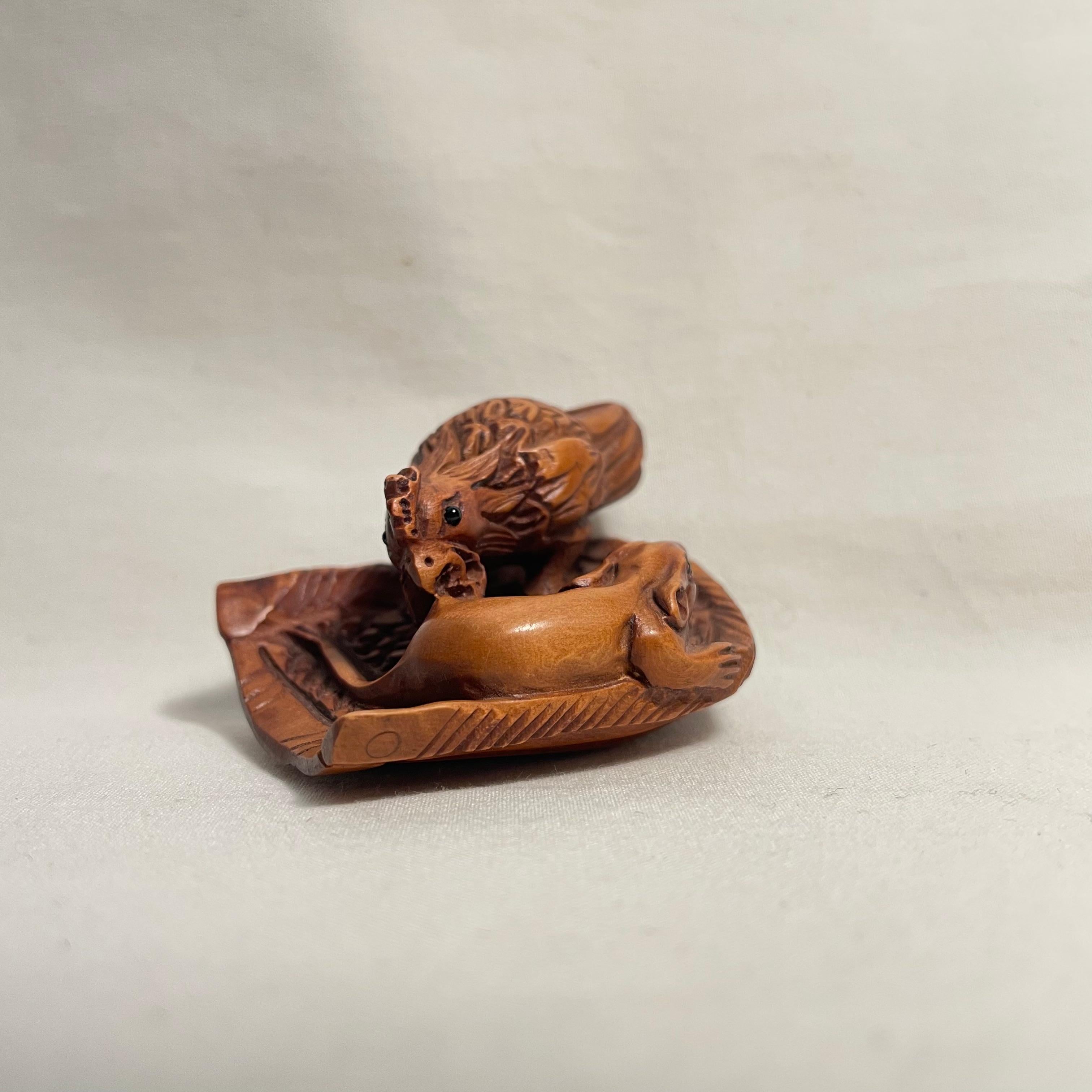 This is an antique wooden netsuke made in Japan around Taisho period 1920s.

Netsuke is a miniature sculpture, originating in 17th century Japan.
Initially a simply-carved button fastener on the cords of an inro box, netsuke later developed into