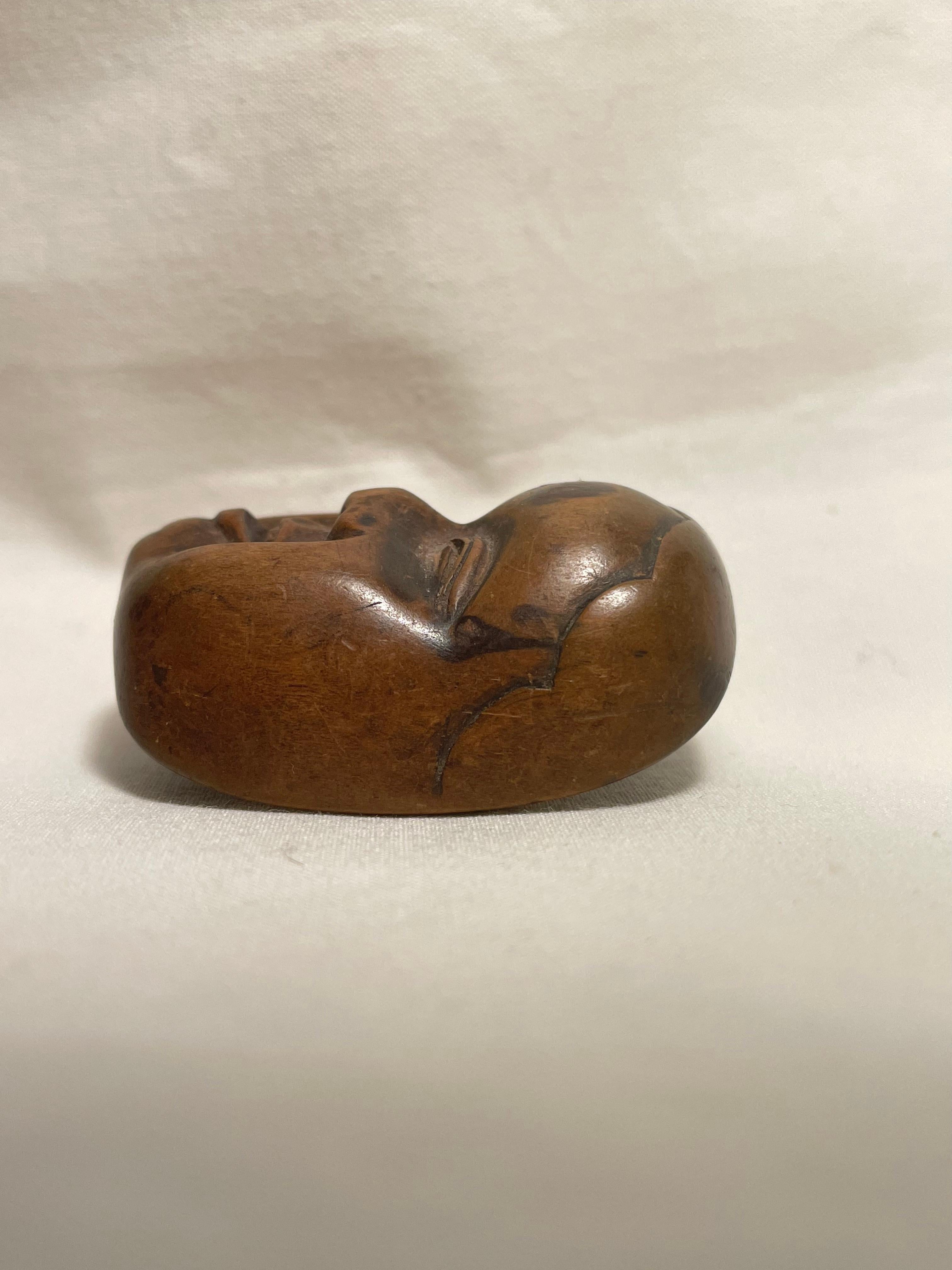 This is an antique netsuke made in Japan around Showa period 1950s.

Dimensions: 4.5 x 3.5 x H2.2 cm
Sculpture: Onnamen 
Era: 1950s (Showa) 

Netsuke is a miniature sculpture, originating in 17th century Japan.
Initially a simply-carved button