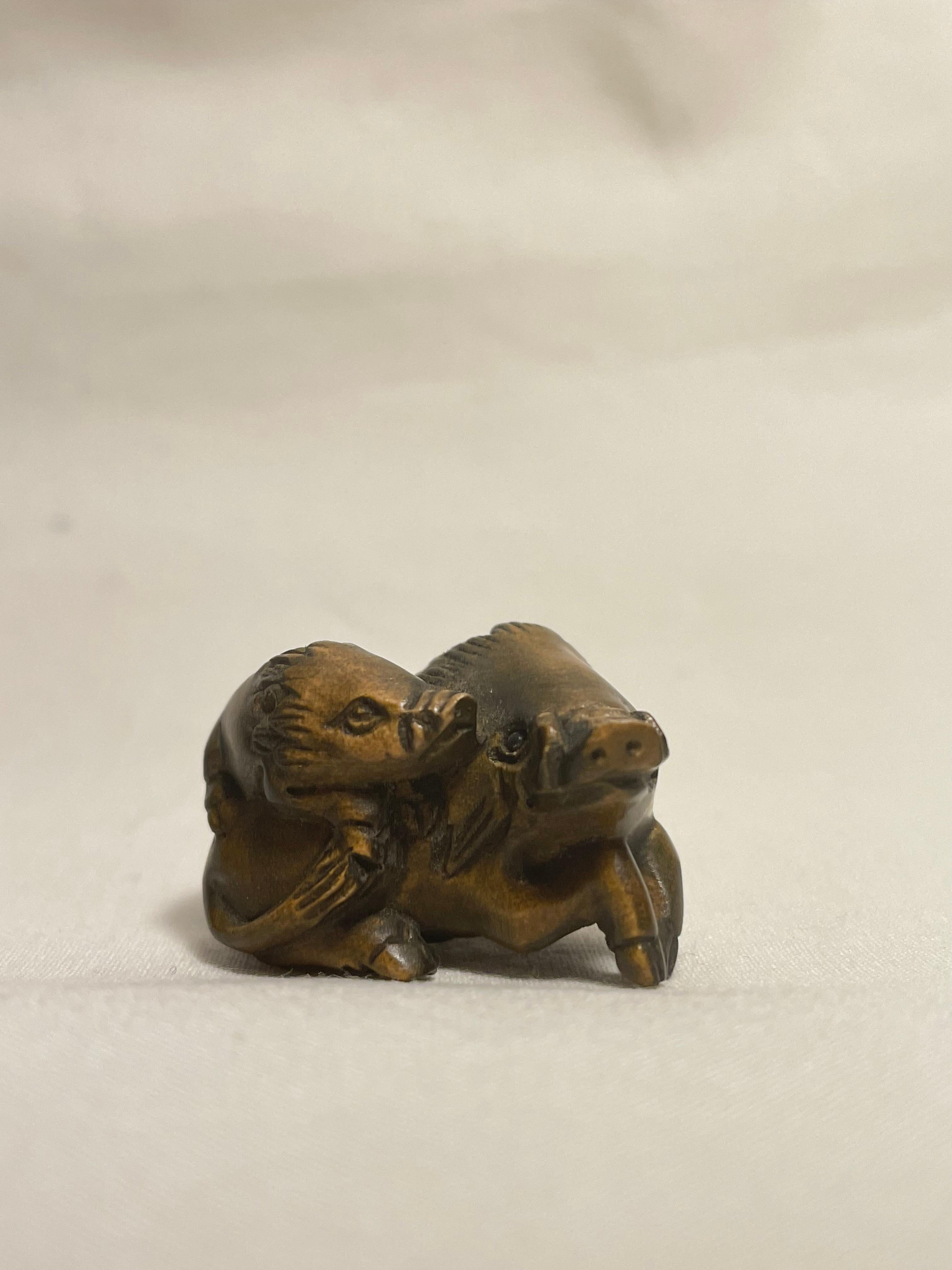 This is an antique netsuke made in Japan around Showa period 1960s.

Dimensions: 2.5 x 2.3 x H2 cm
Sculpture: Wild Boar
Era: 1960s (Showa) 

Netsuke is a miniature sculpture, originating in 17th century Japan.
Initially a simply-carved button